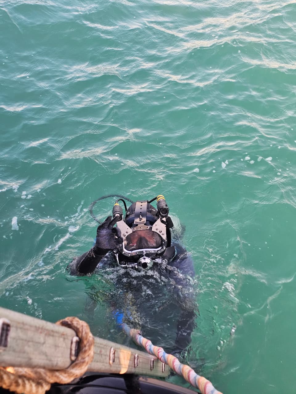 black and red life buoy on brown wooden dock during daytime