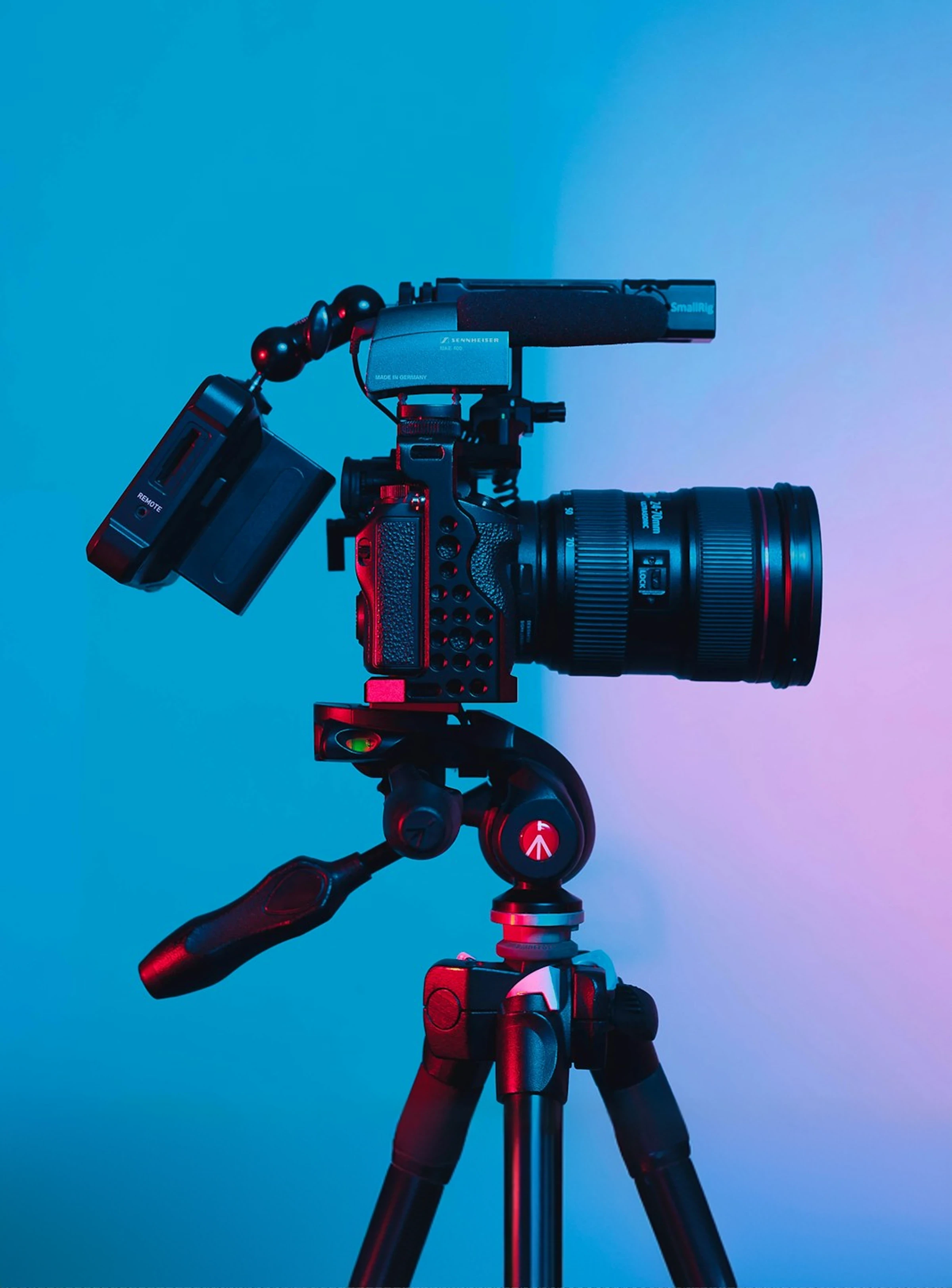 Professional cinema camera on a tripod against a blue and purple gradient background