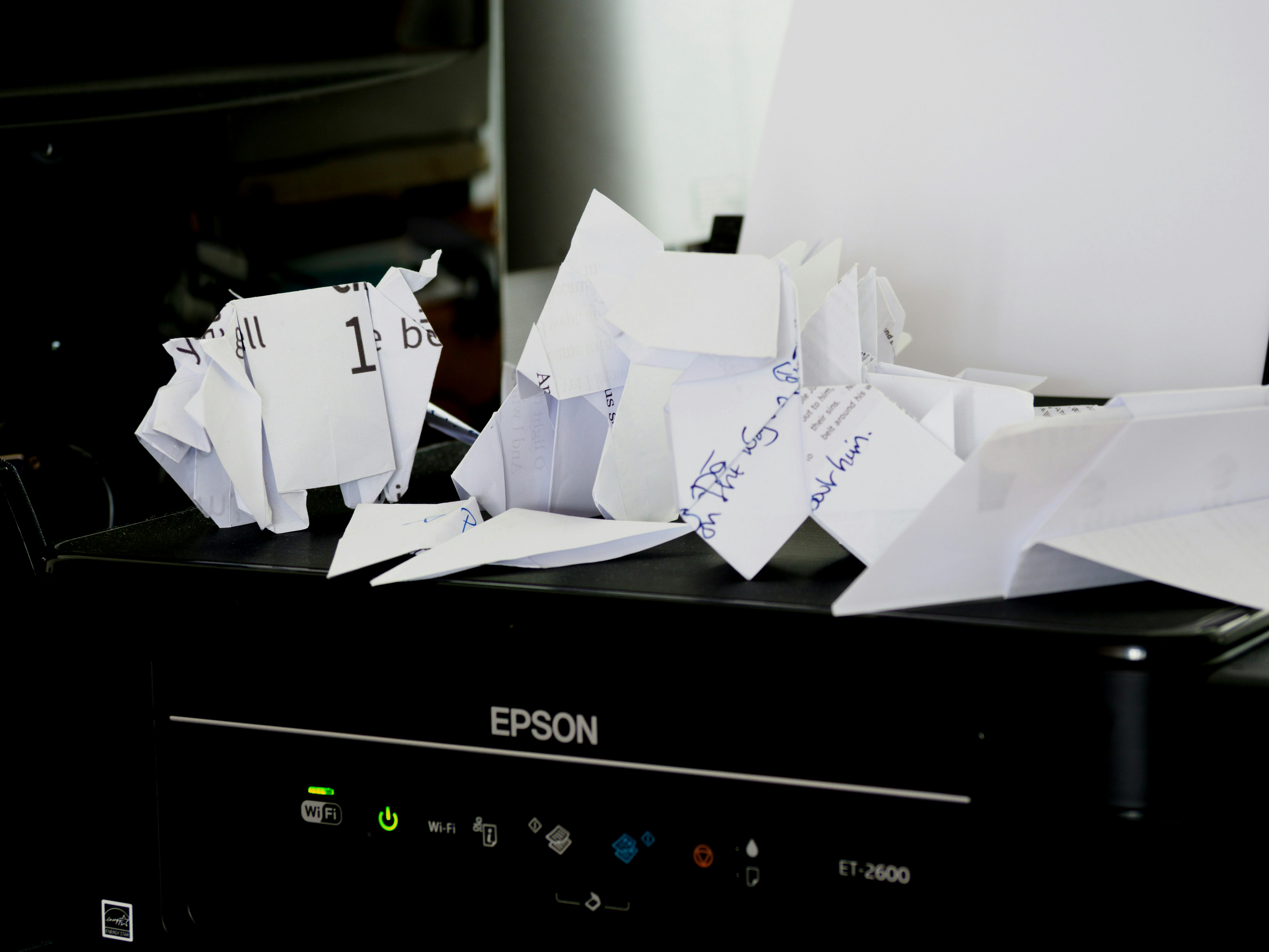 Printer with crumpled draft pages symbolizing common cease and desist letter drafting mistakes