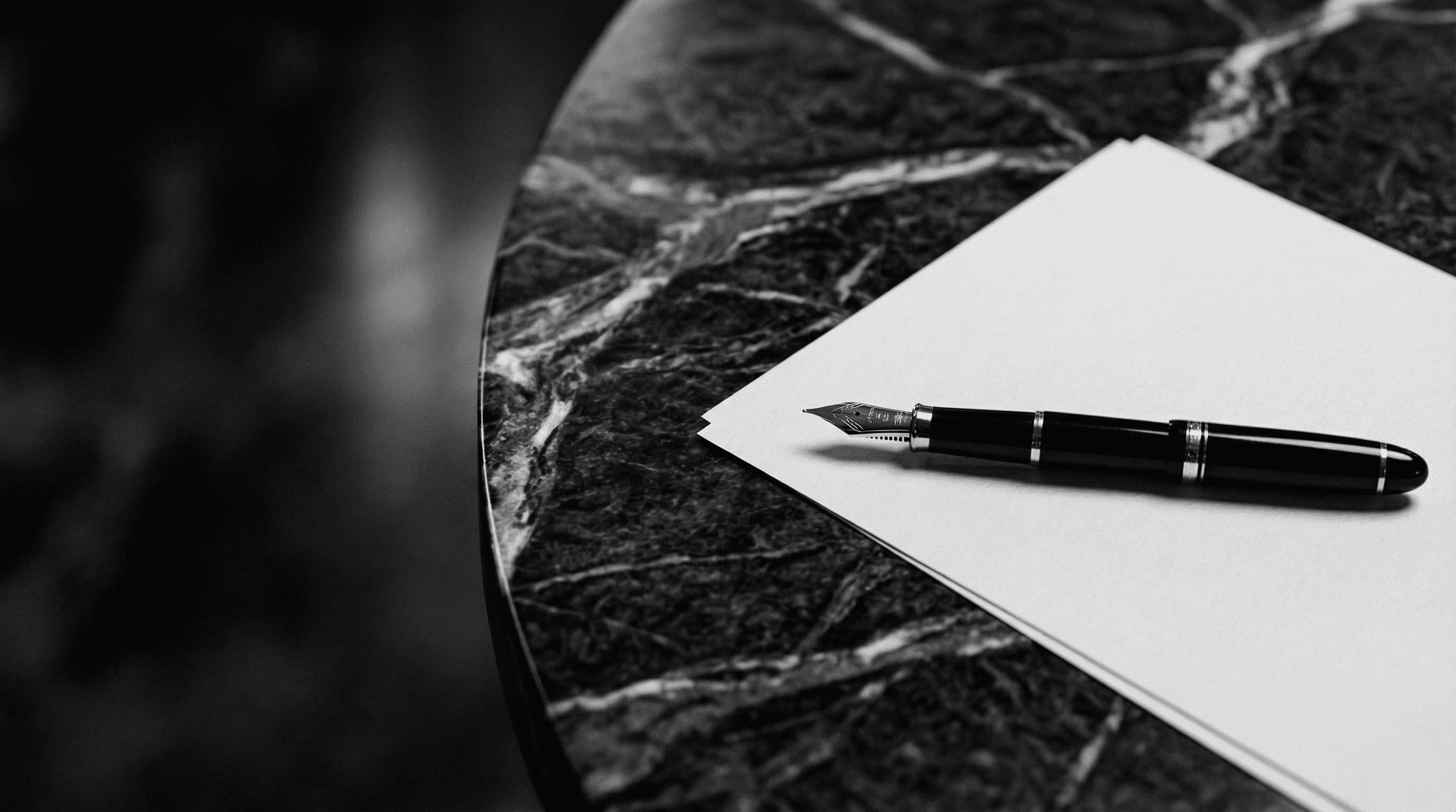 Aerial view of a winding road cutting through rocky terrain with patches of grass.