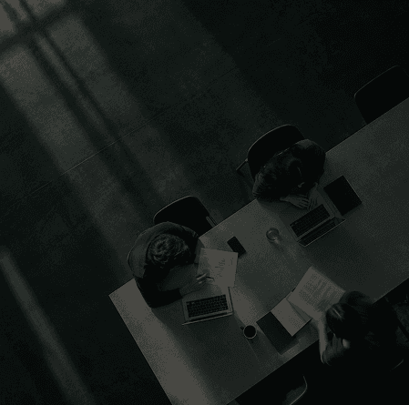 Overhead view of a team working with laptops around a meeting table