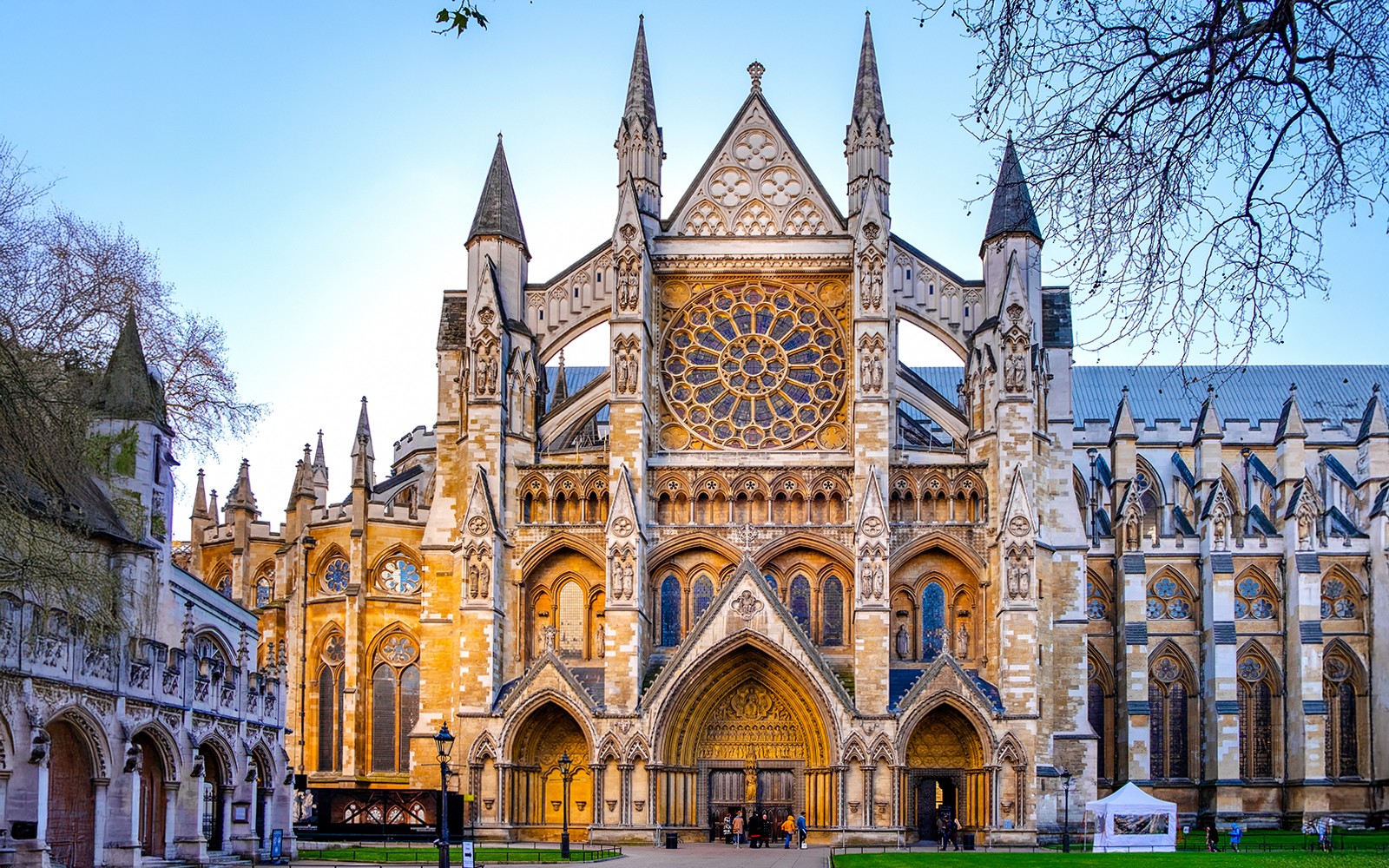 Northern entrance of Westminster Abbey with tourists entering for a guided tour in London.