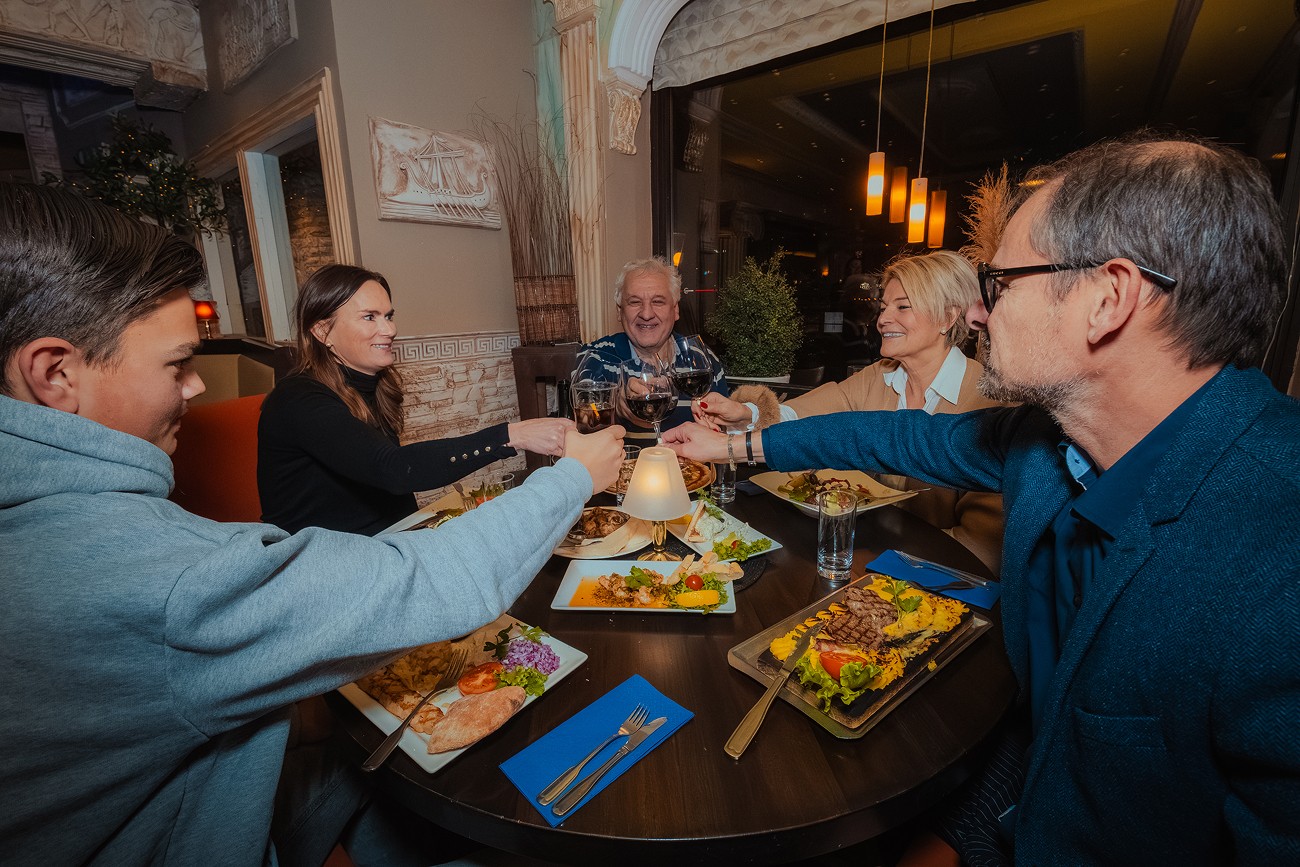 A person holding two sandwiches in their hands