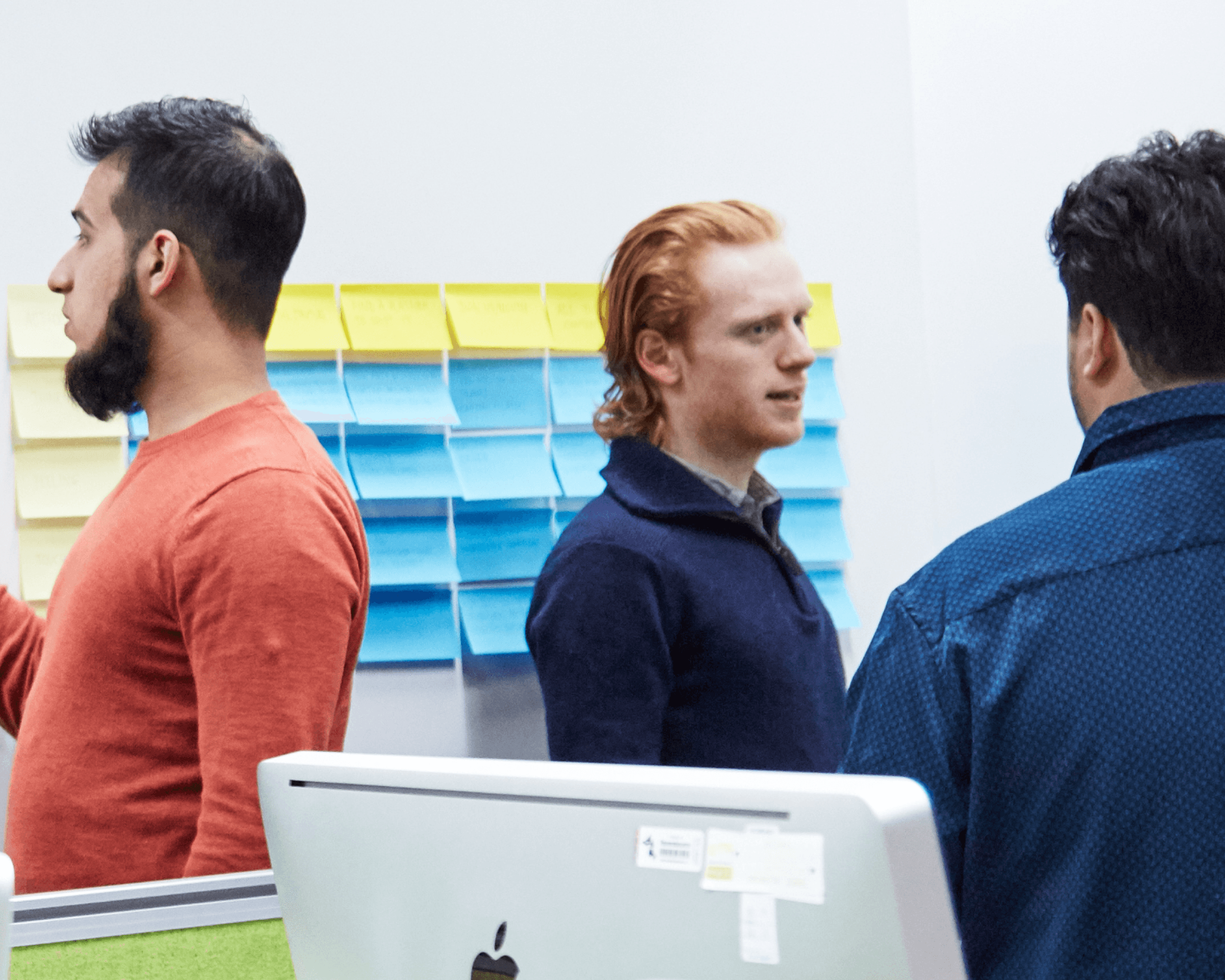 Photo of each legal requirement put on post it notes. Five people are discussing which could stay or go.