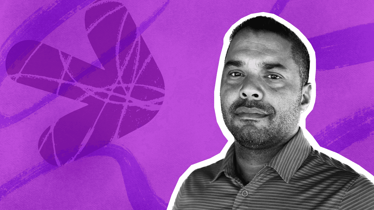 A confident man with a short beard and striped shirt, in monochrome, against a vibrant purple Birdie background with.