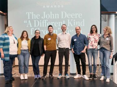 John Deere team member from Signal Theory accepting a Signals of Culture award at annual meeting.