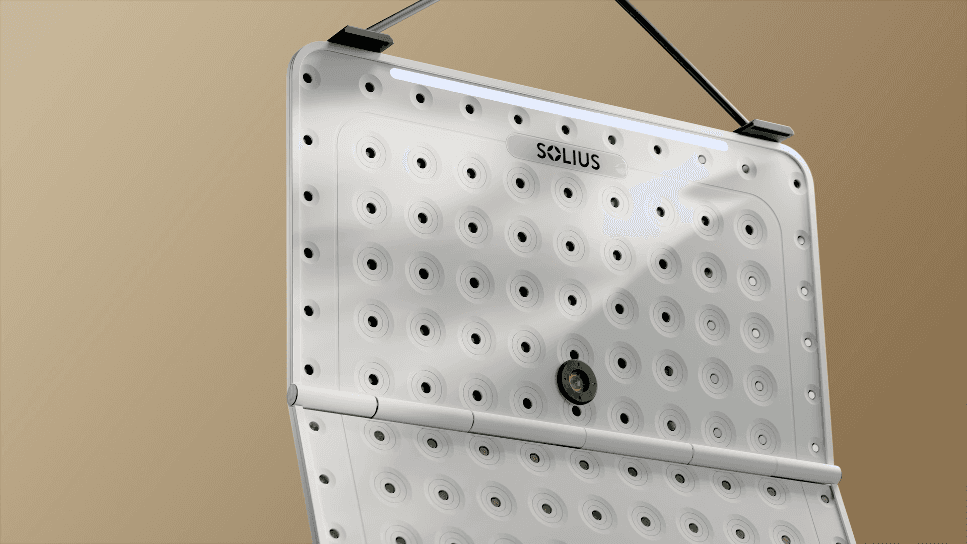 Close-up of a white medical or therapy device panel with evenly spaced perforations, subtle green indicators, and the Solius logo on a neutral background.
