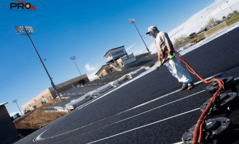 Professional running track construction with rubber surfacing and lane markings at school stadium