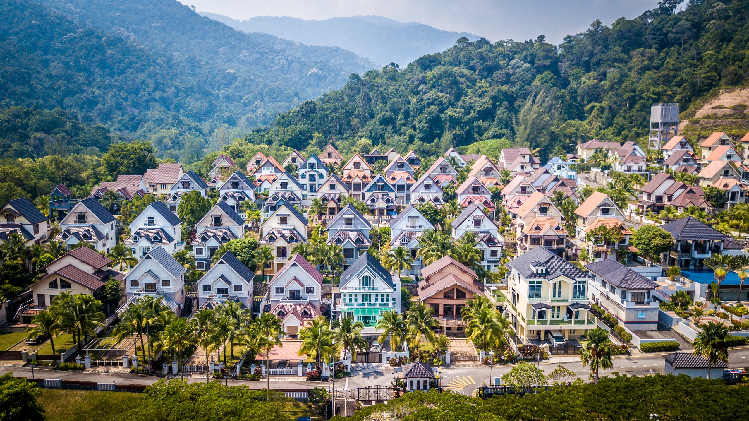 Rows of pastel hillside chalets among the forested slopes of the Malaysian highlands.
