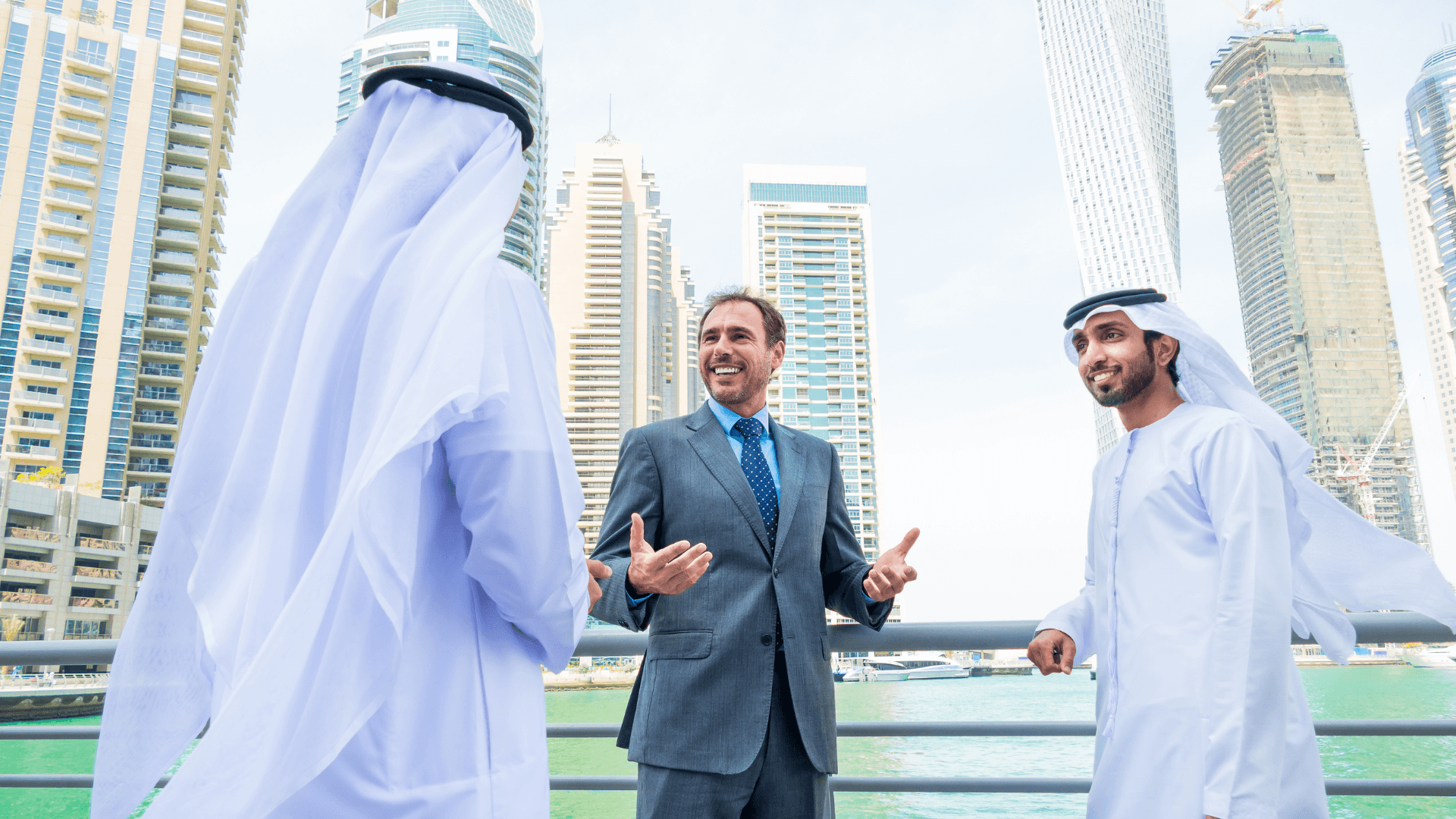 Three hospitality consultants discussing hotel project plans outdoors in a modern city environment | Lunasole Hospitality
