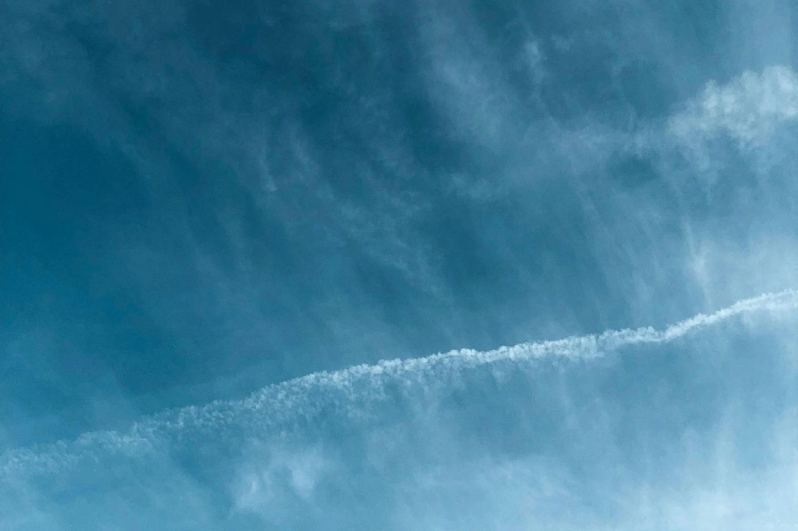 Abstract pattern of wispy white clouds against a blue sky