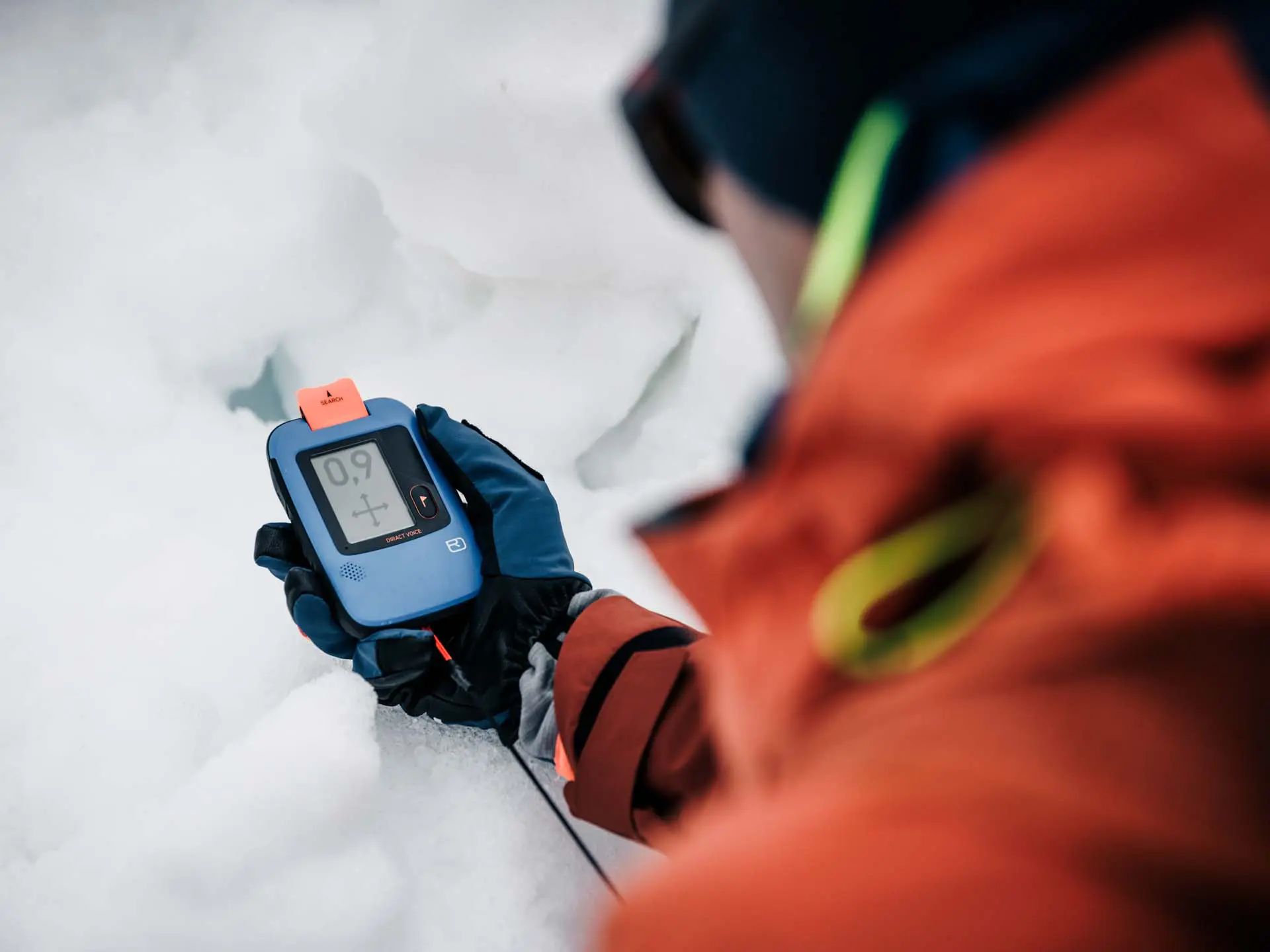 Close-up of an avalanche transceiver in use during a companion rescue training exercise in the snow