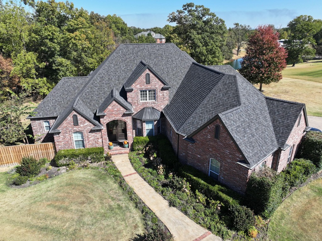 Brick house with a black-shingled roof.