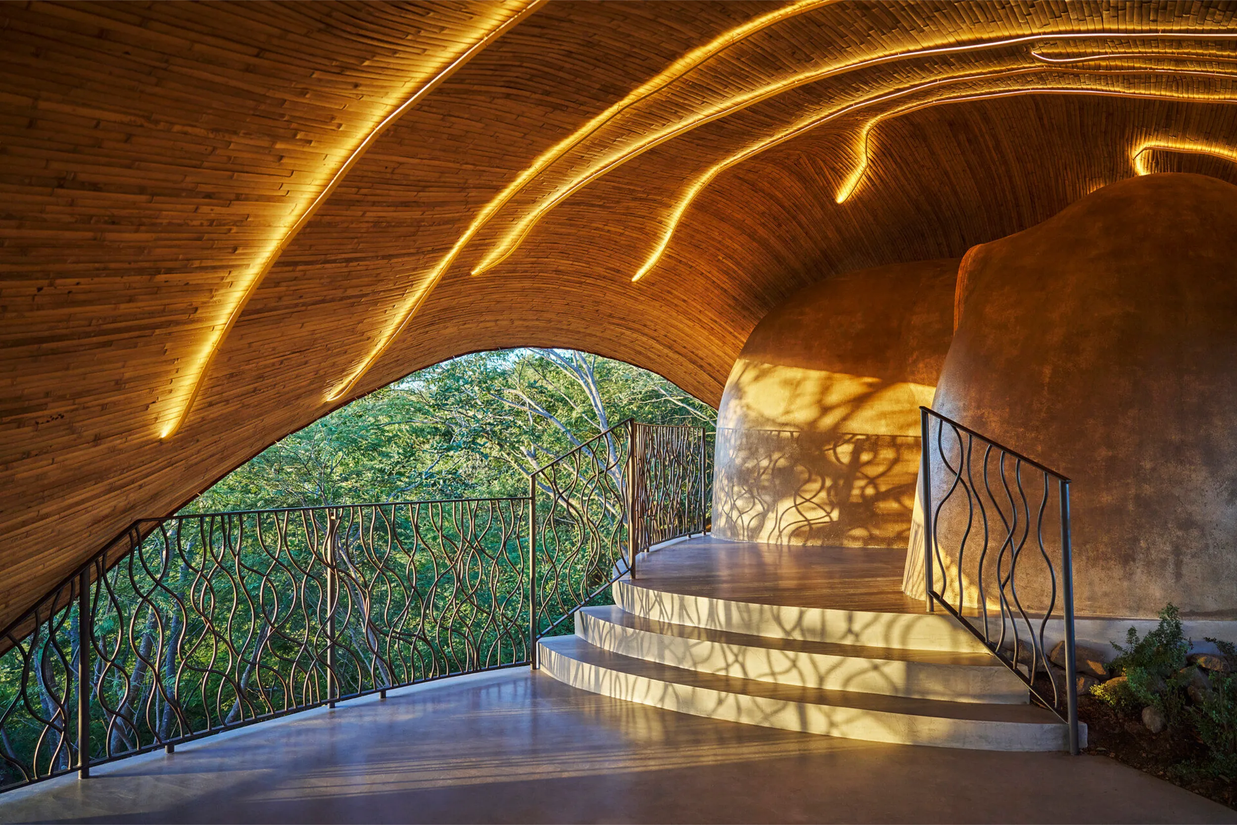 Monumental sustainable bamboo structure at Hyatt Impression Isla Mujeres, showing the iconic bio-parametric architecture against the blue sky.
