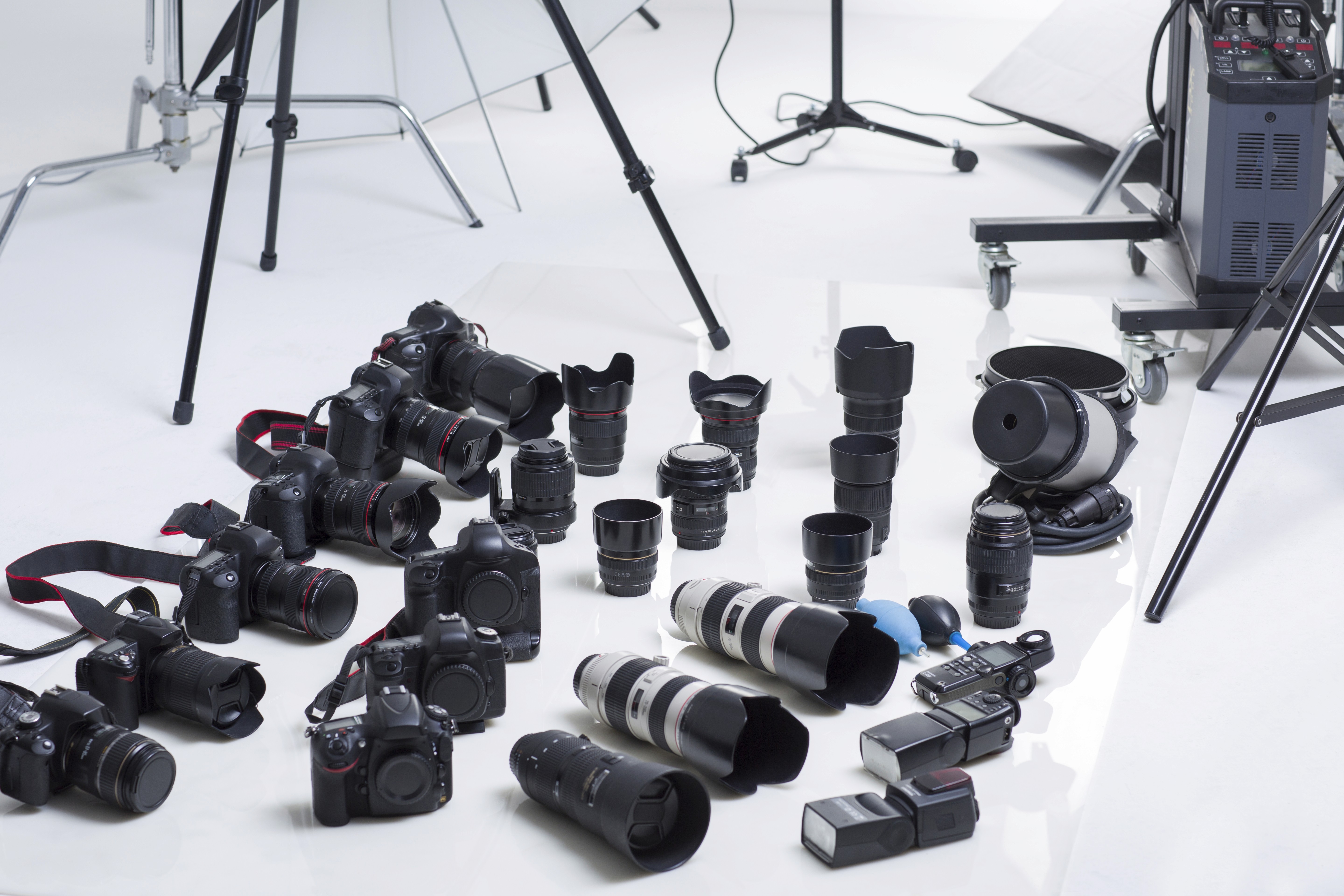 Collection of professional cameras and lenses arranged in a studio, representing the equipment used to create high-quality 360° product videos for brands.