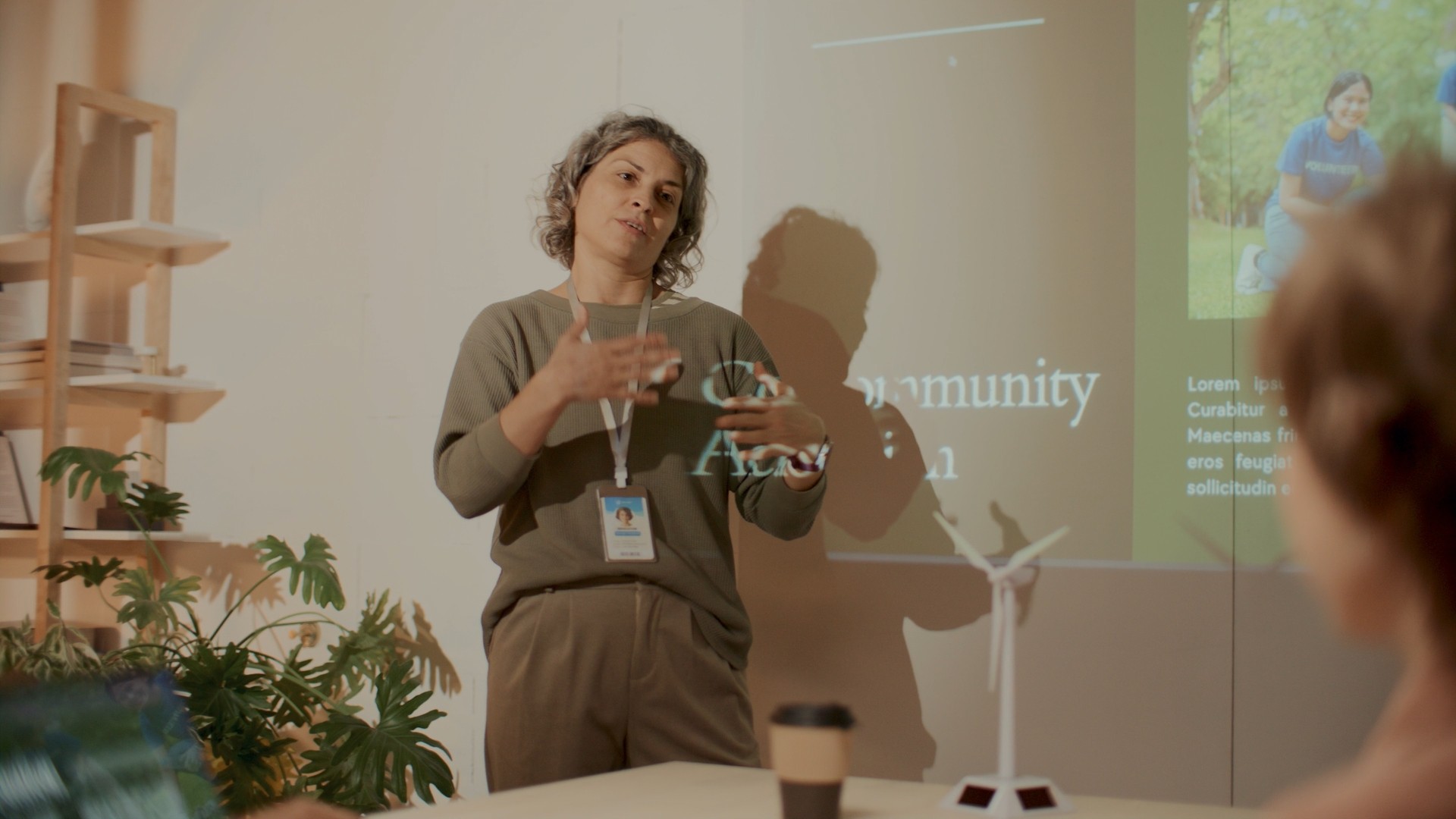 A women presenting in front of a group.