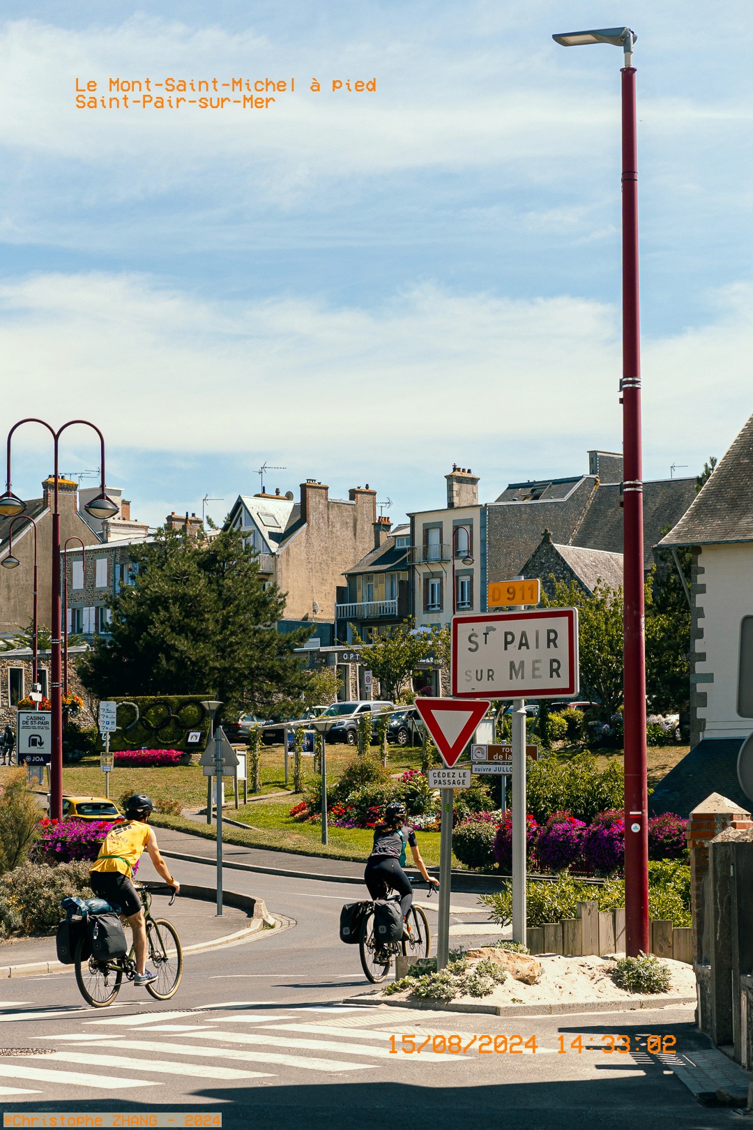 Deux cyclistes quittant le village, randonnée longeant la côte vers le Mont.