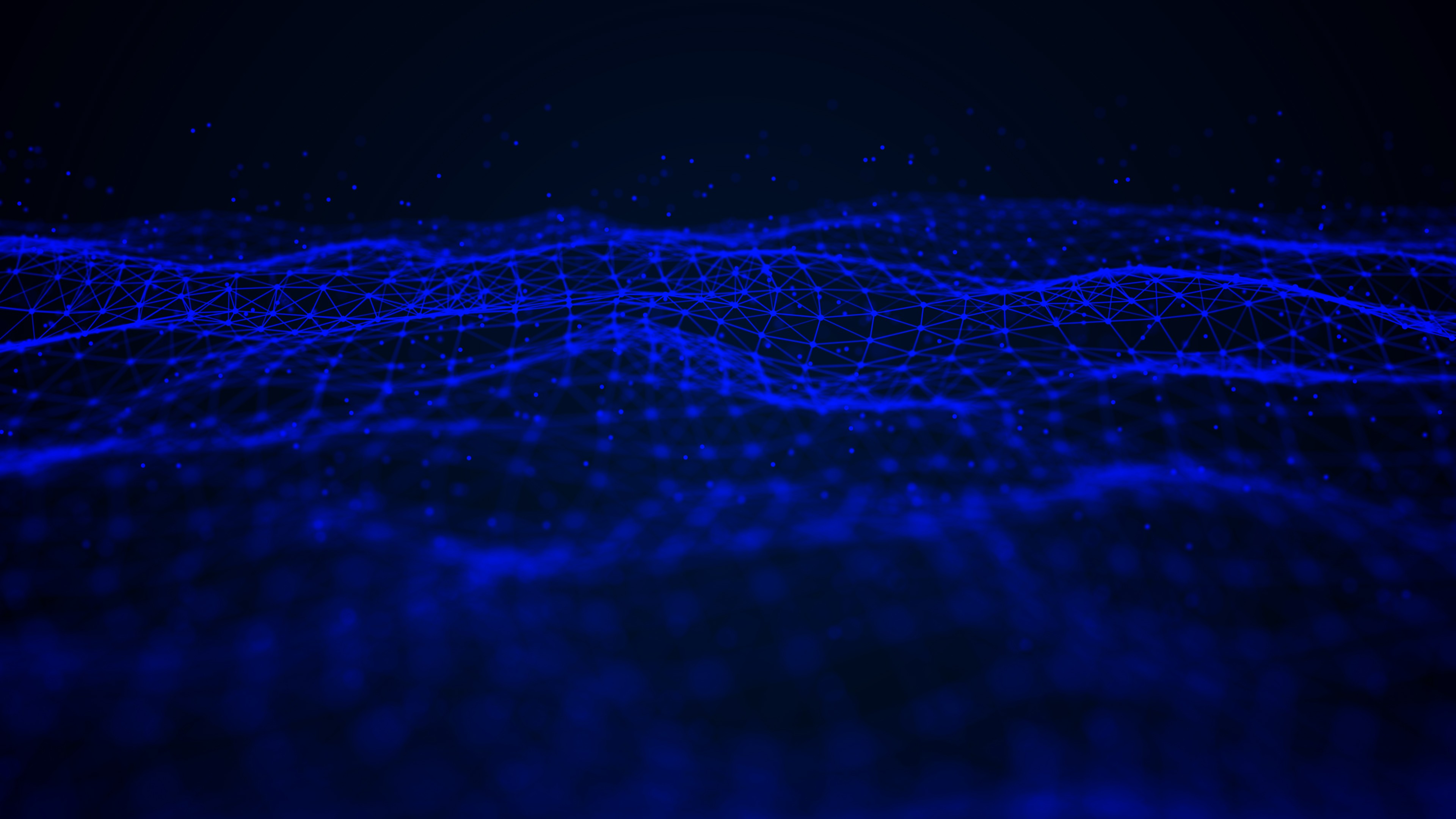 Close-up of a scientist holding a tray of petri dishes with purple cultures, wearing gloves and safety gear.