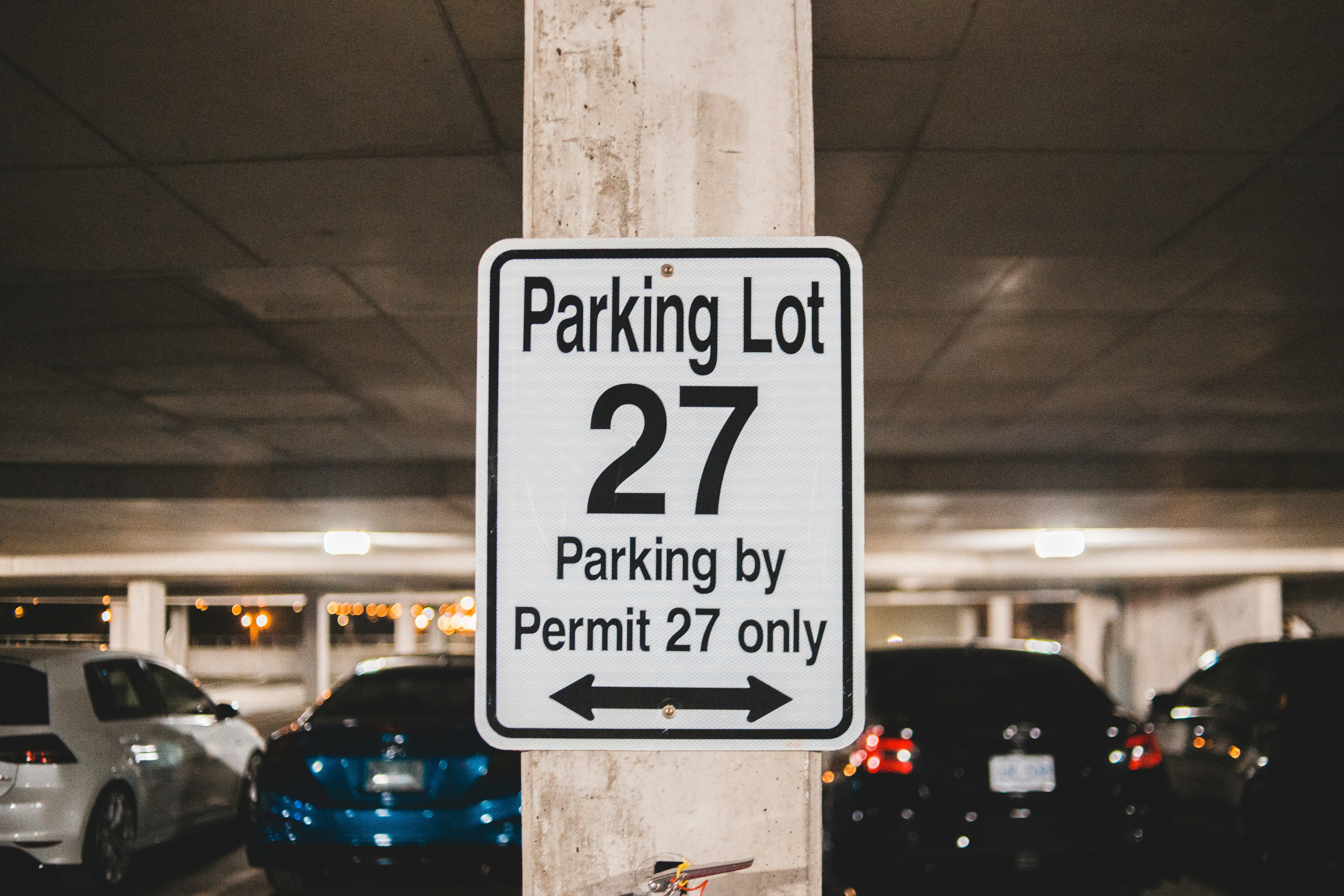 Sign in a parking garage indicating Parking Lot 27 is permit-only.