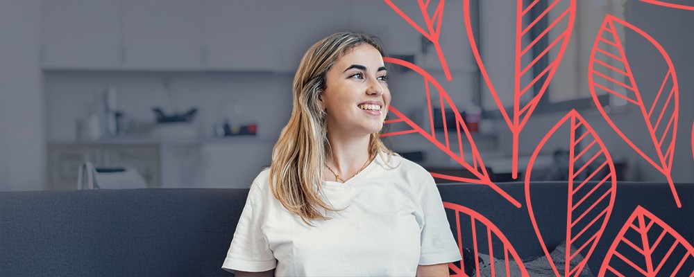 Woman at home staring off and smiling, happy with her life