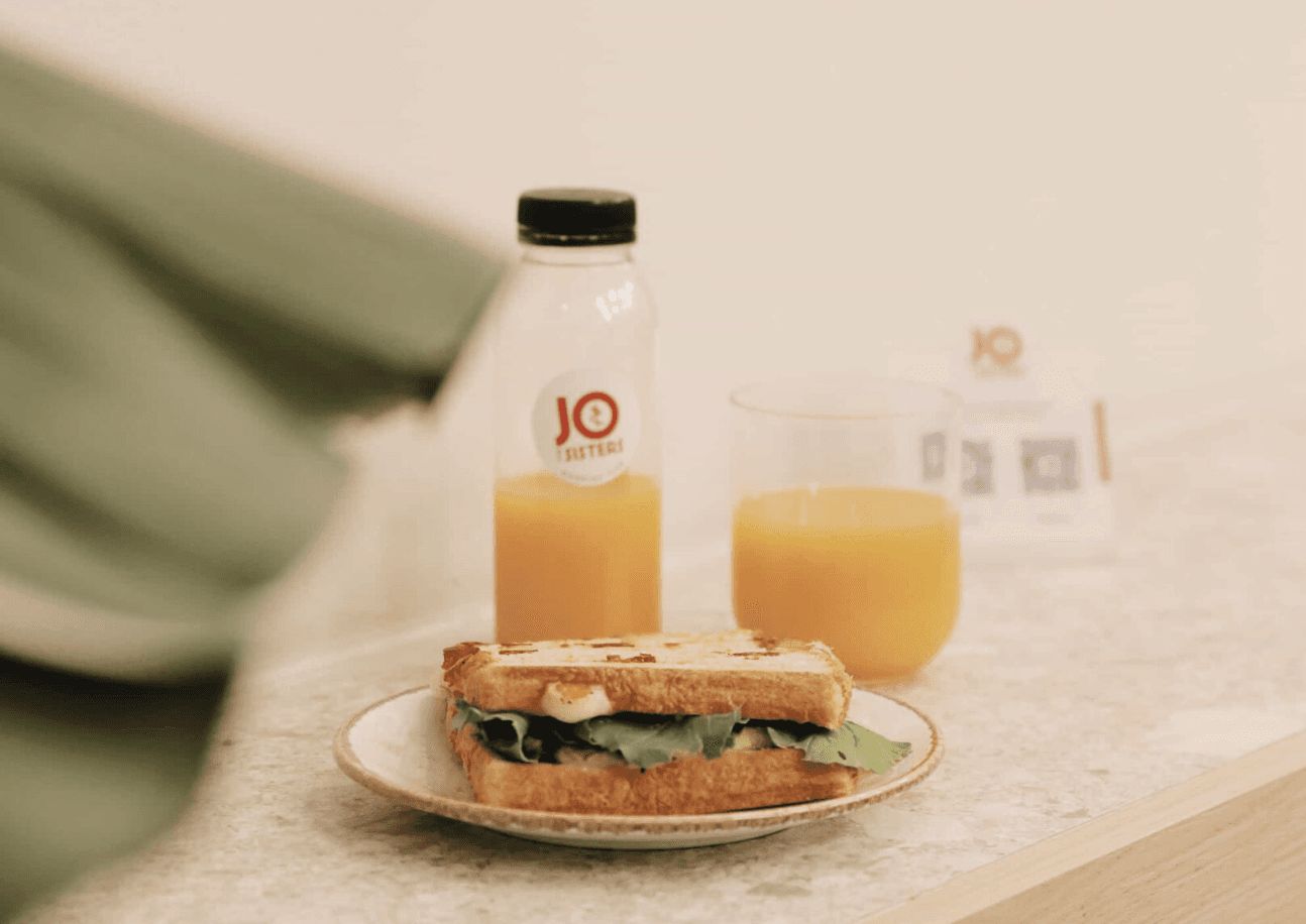  Healthy breakfast with whole grain sandwich paired with a cold-pressed juice