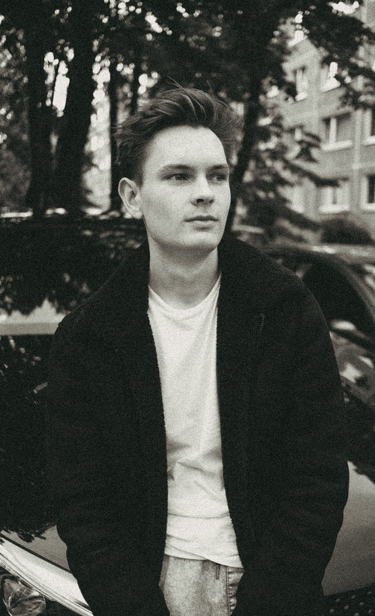 Portrait of a person in dark clothing speaking on a phone