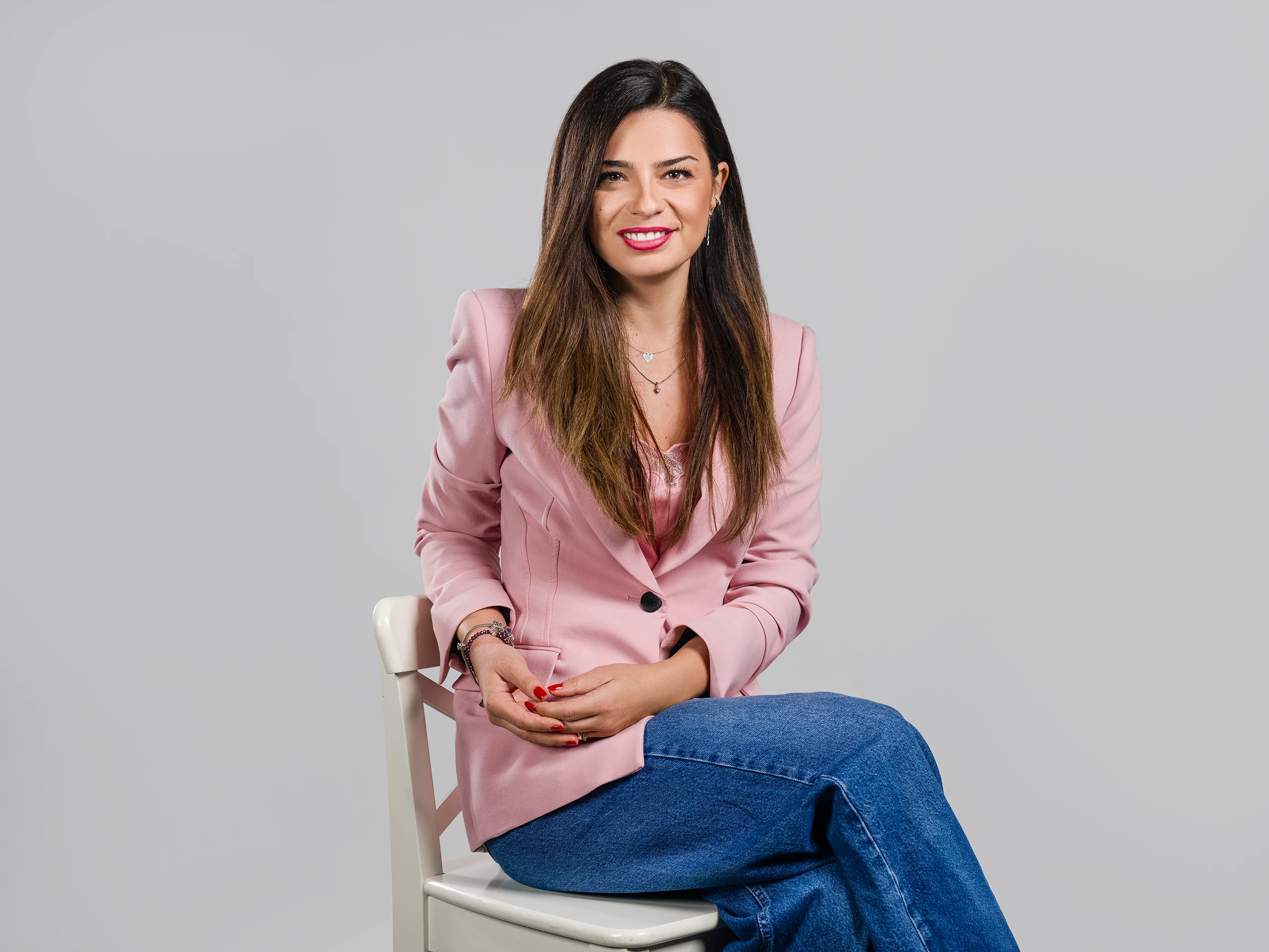 Corporate lifestyle portrait of a confident woman, captured in a relaxed and natural pose.