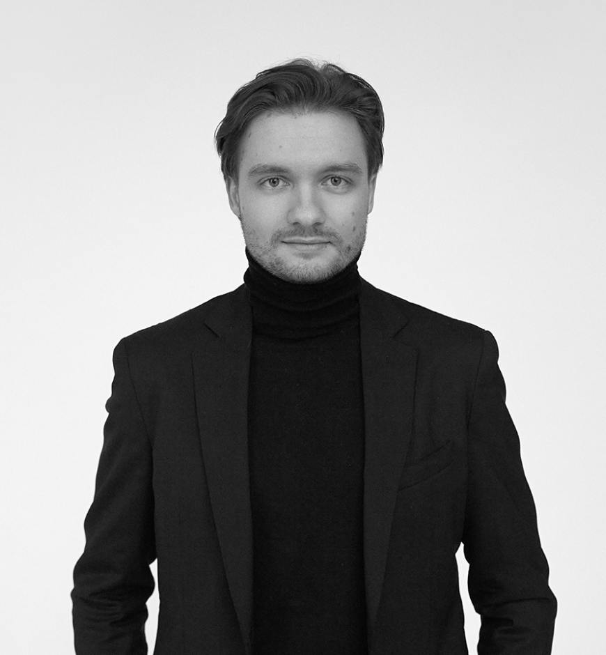 A man in a suit smiling