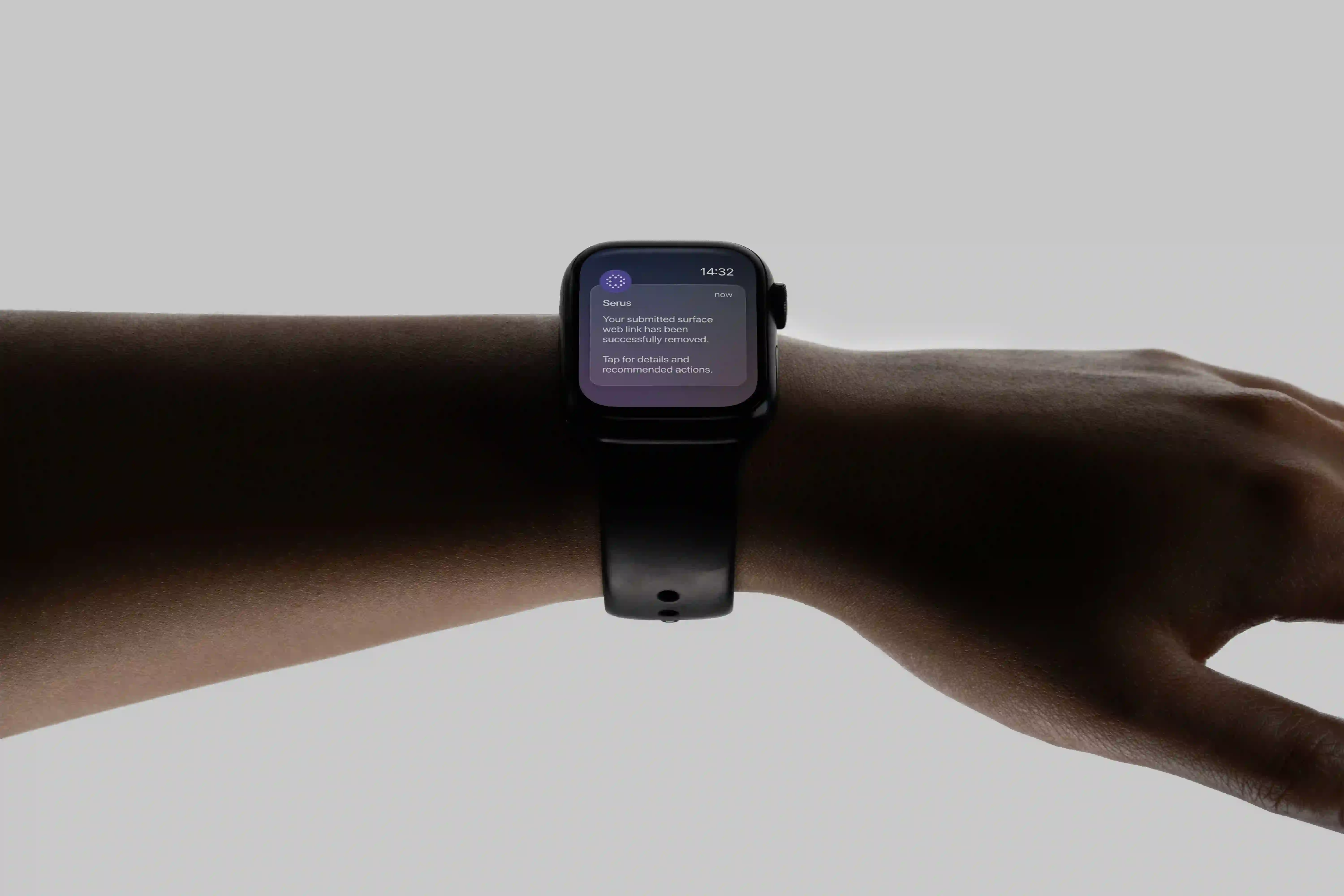 Smartwatch on a wrist showing a notification on the screen for real-time updates