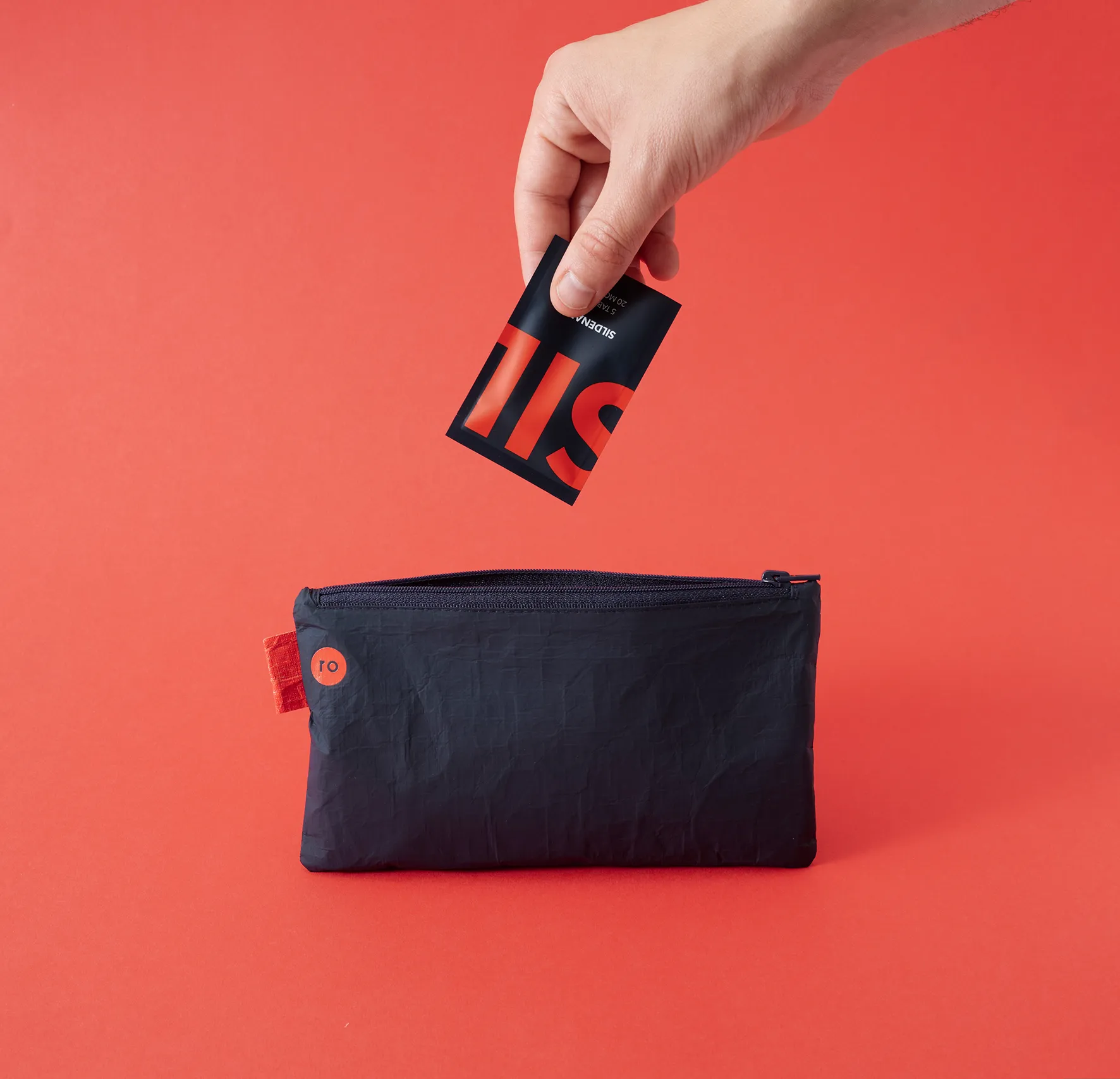 Hand inserting a branded card into RO healthcare product packagin