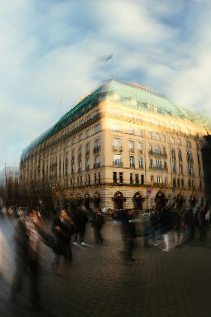 Blurry street scene with a building and people