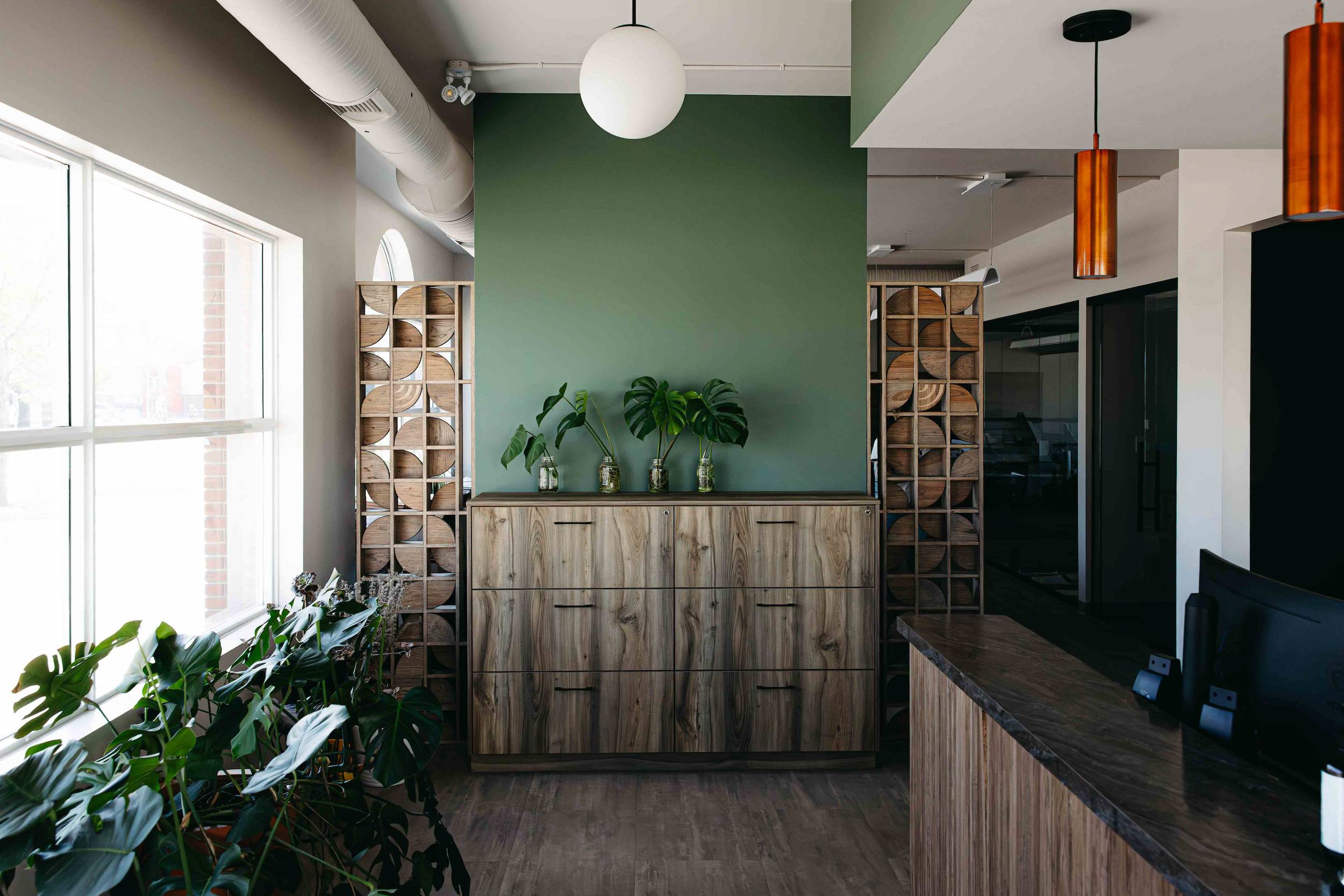 The lobby of Crosy Hanna, a Saskatoon business, showcasing custom woodwork feature wall