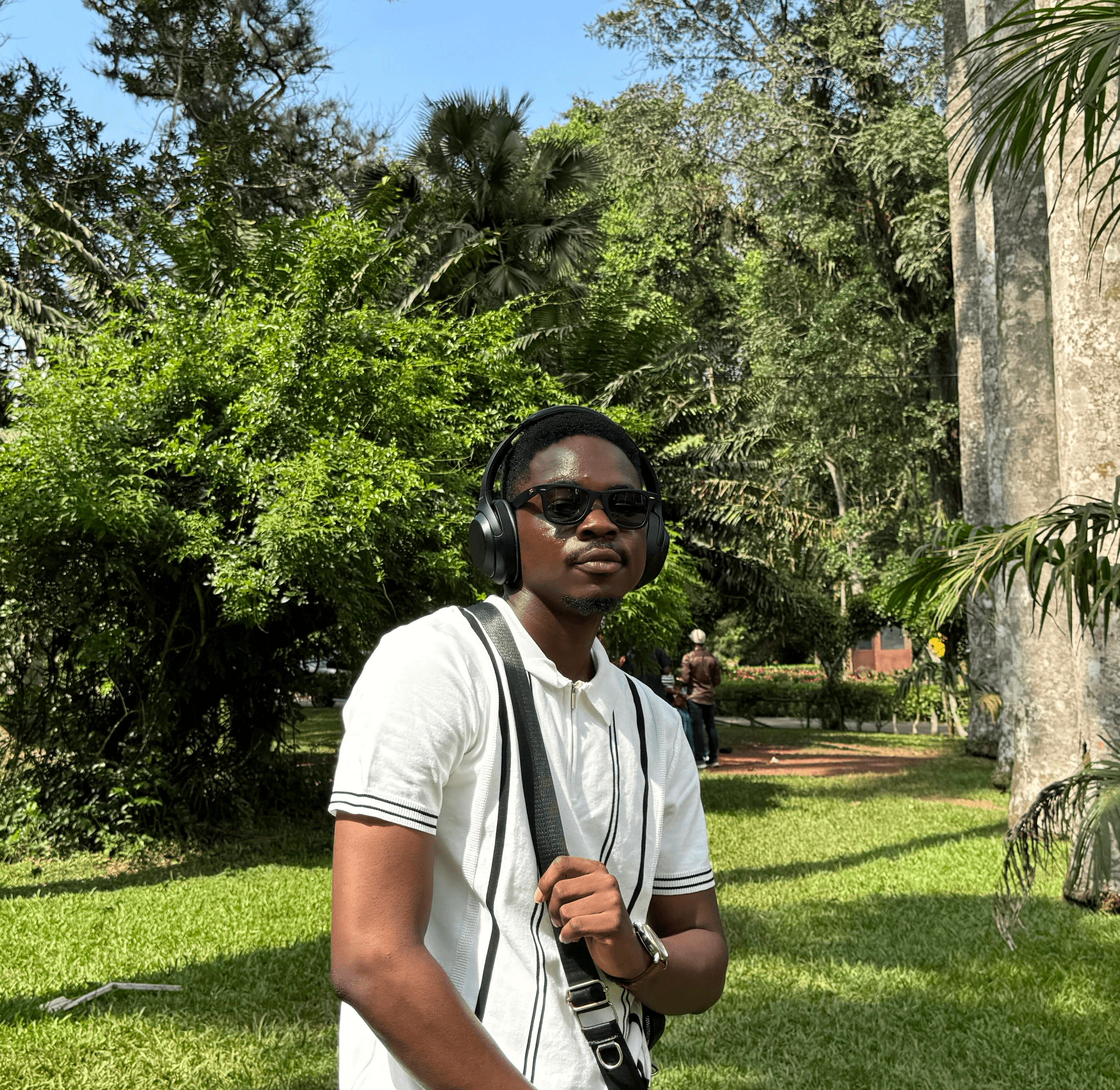A thoughtful young person with dark hair gazes to the side, captured in soft black and white lighting.