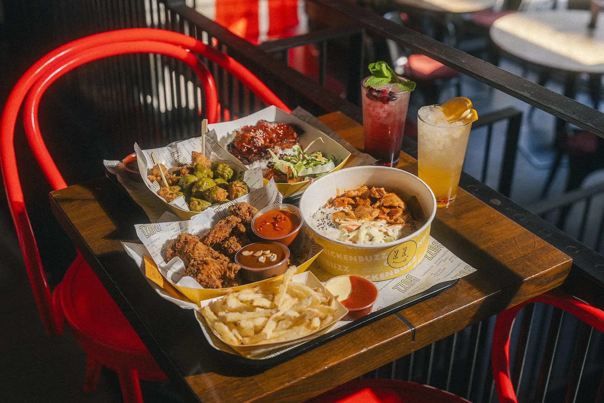 table spread with chicken buzz food and drinks
