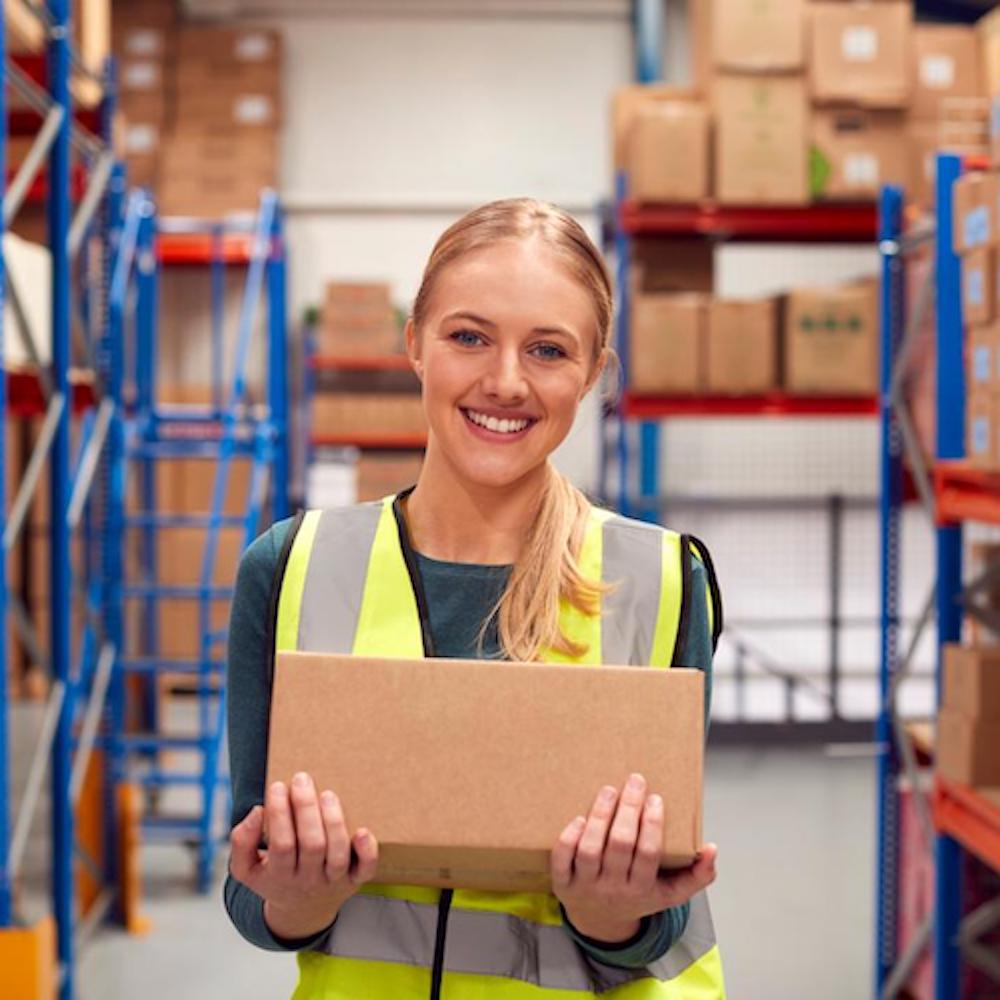 A person carrying a box in a warehouse