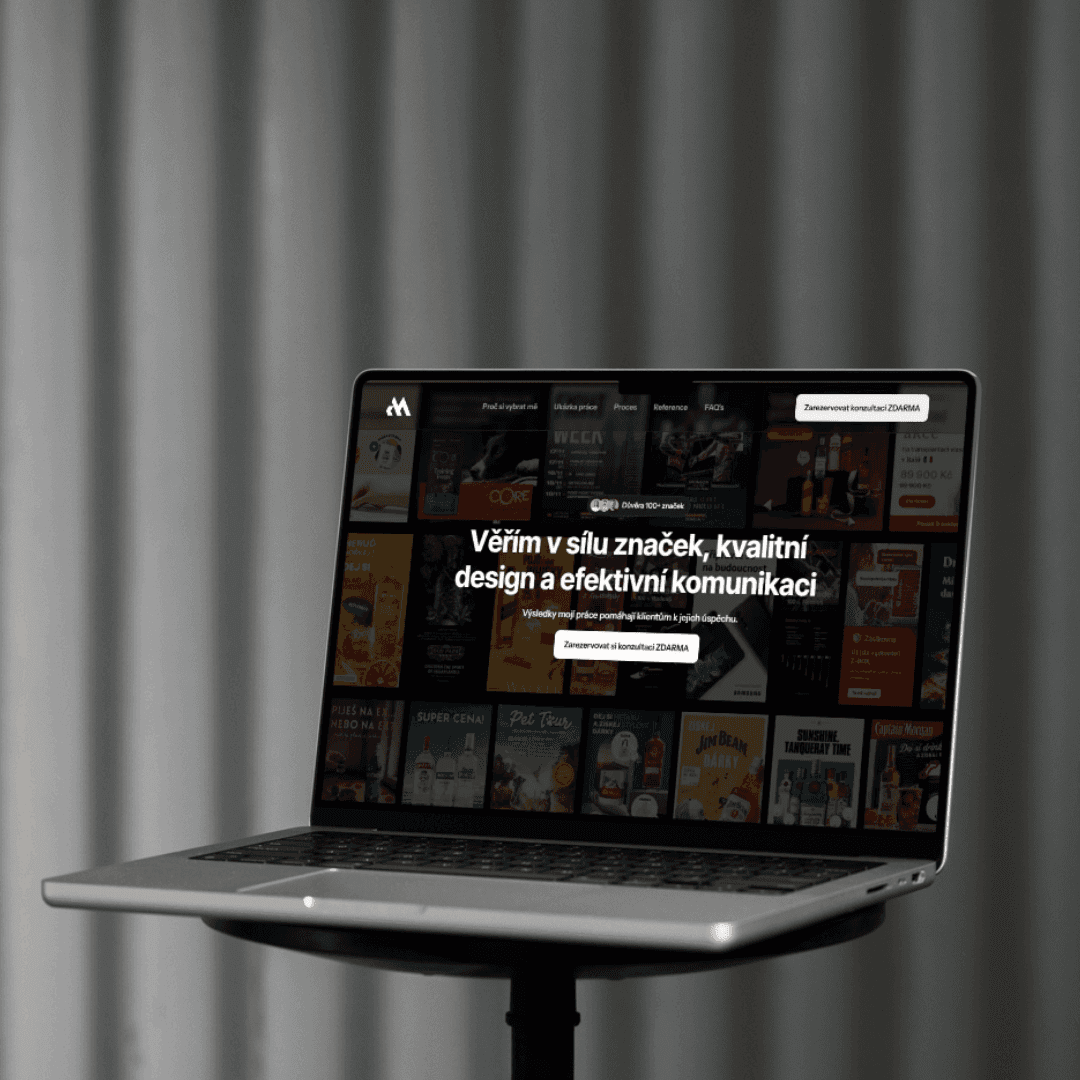 Red trolley car driving down a tree-lined street.