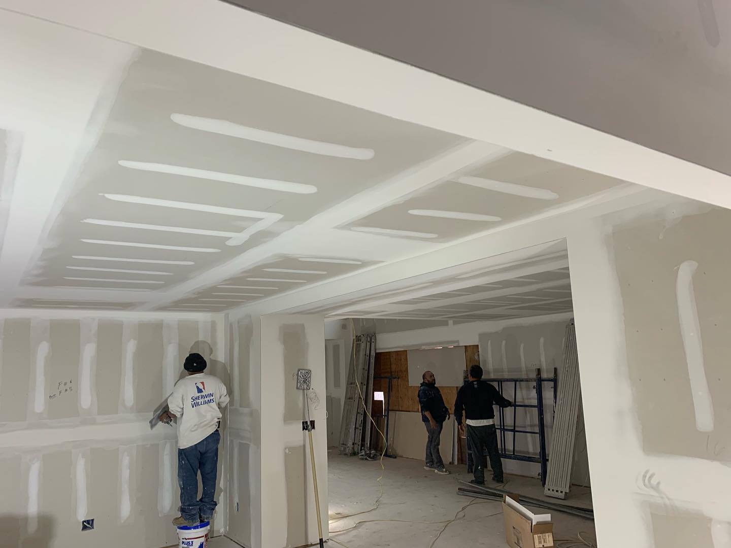DWS crew finishing drywall in a large great room