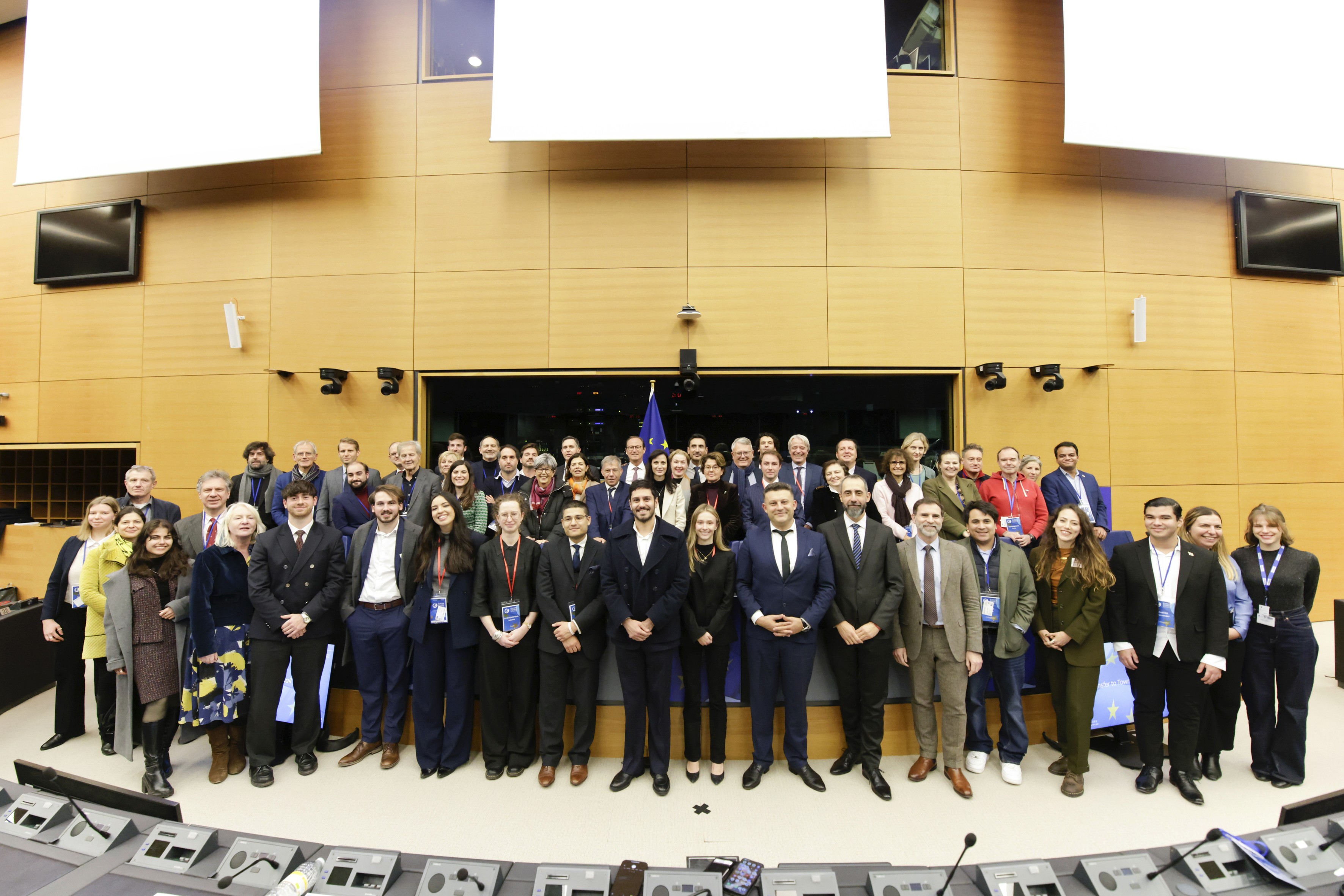 group of women in red and white dress standing on brown wooden bar during daytime