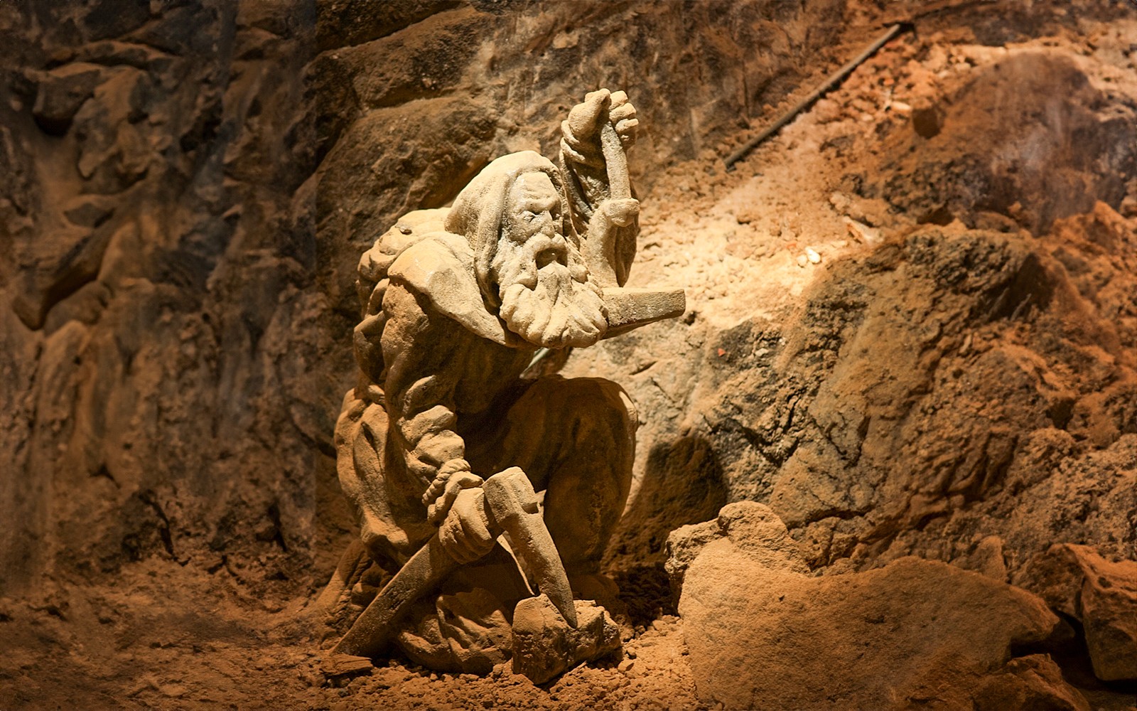 Miner statue in Bochnia Salt Mine, Poland, depicting historical salt mining activities.