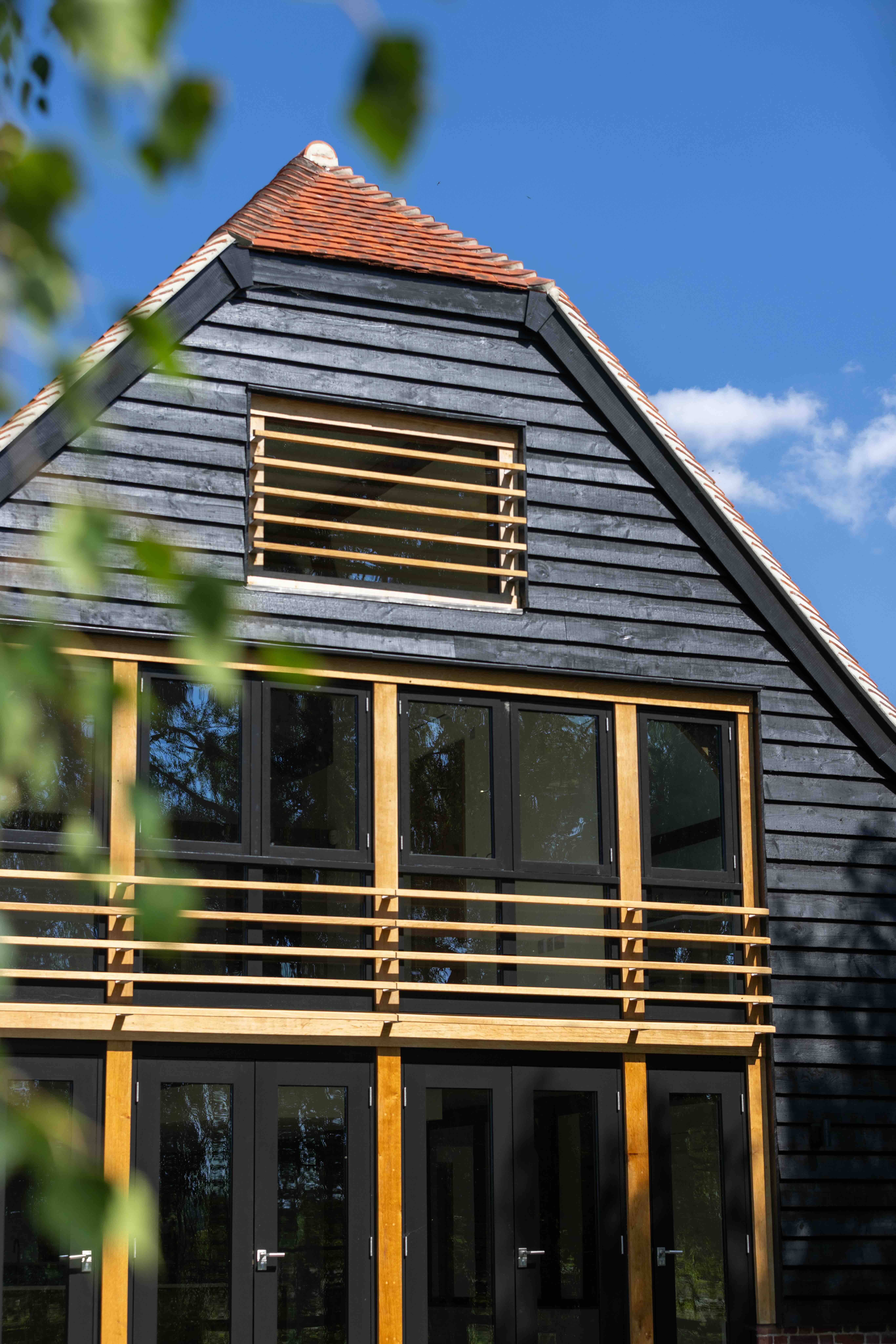    External view of oak-framed barn reconstruction, re-establishing the character of a historic agricultural building in Oxfordshire
