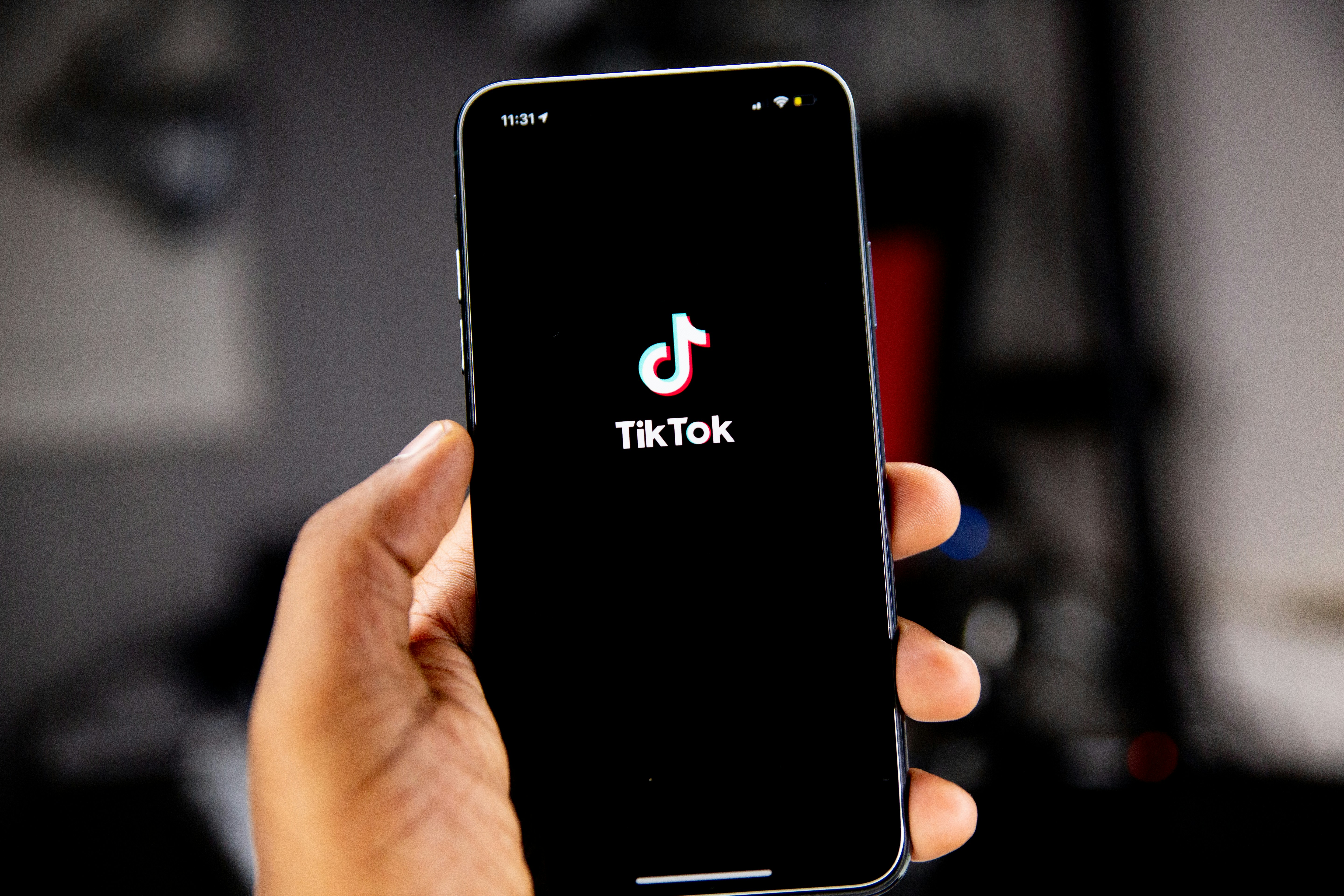 Tiktok app loading up on phone - tik tok ai voice generator 