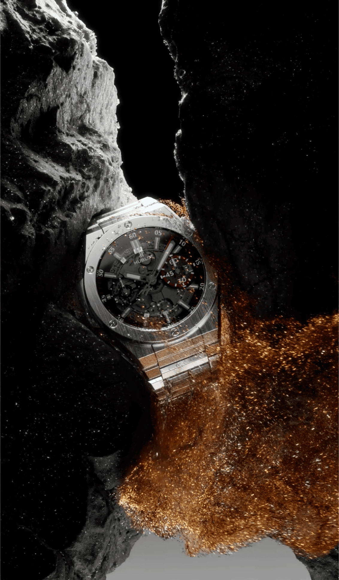 A rugged Hublot watch is embedded within a dark, rocky crevice, surrounded by shimmering gold dust or sand