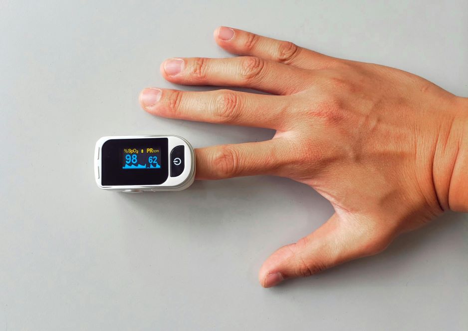 woman in blue sports bra and blue denim shorts standing on wooden dock during daytime