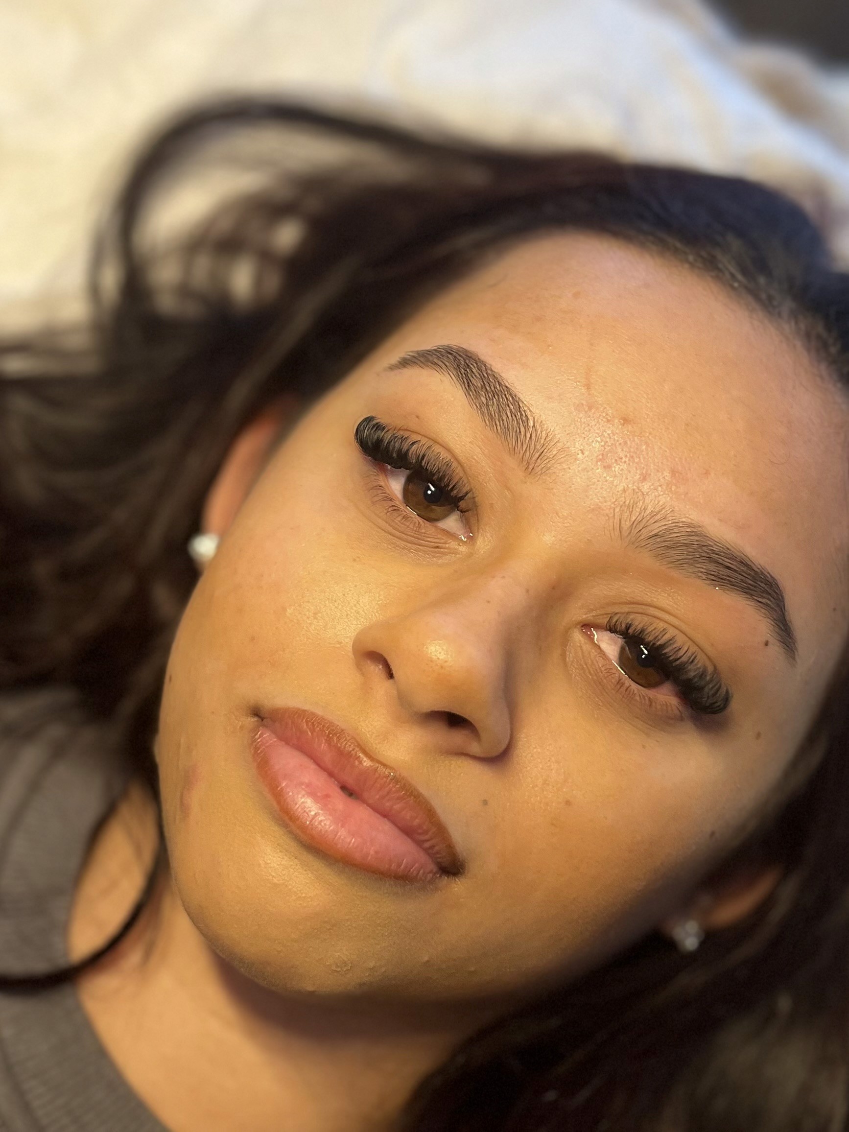 Close-up of a young person with long hair resting on a beauty bed