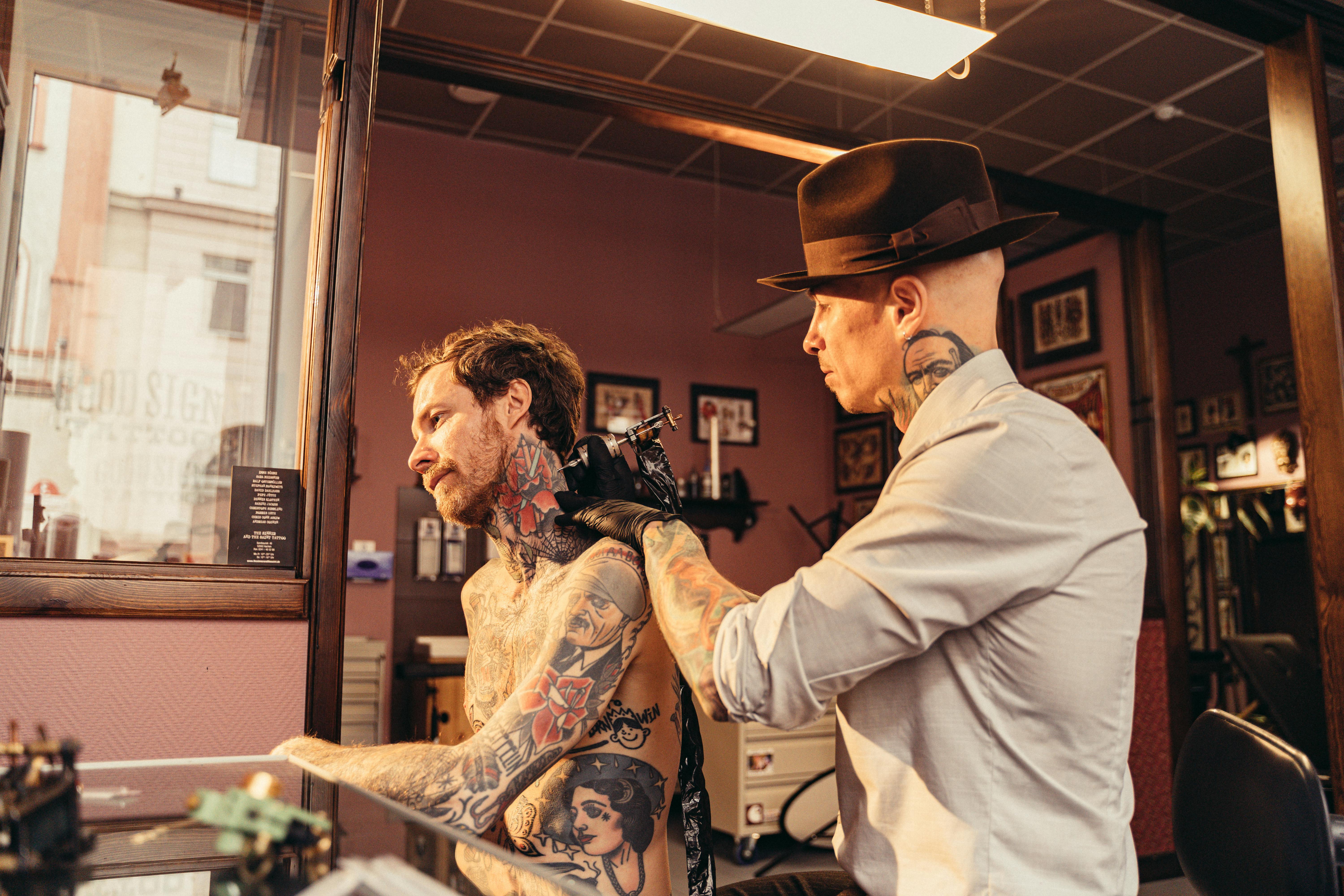 a man getting a tattoo on his arm