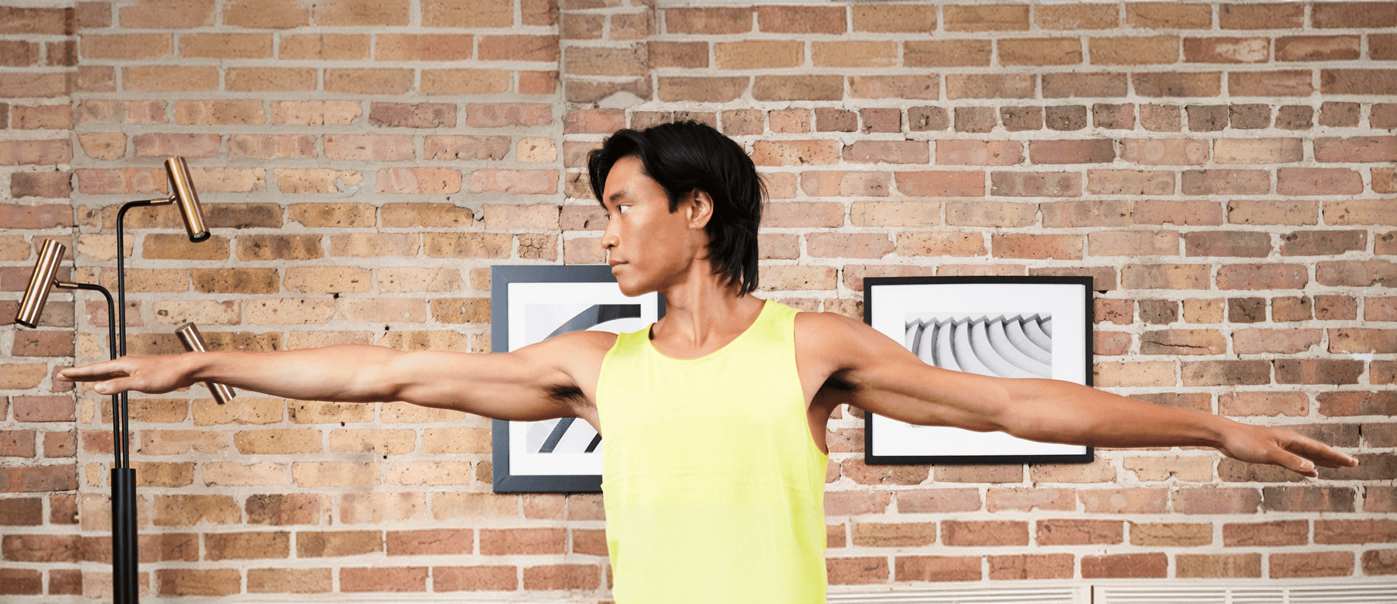 Blurred portrait of a person in an orange patterned shirt with glowing glasses, creating a futuristic and artistic vibe.