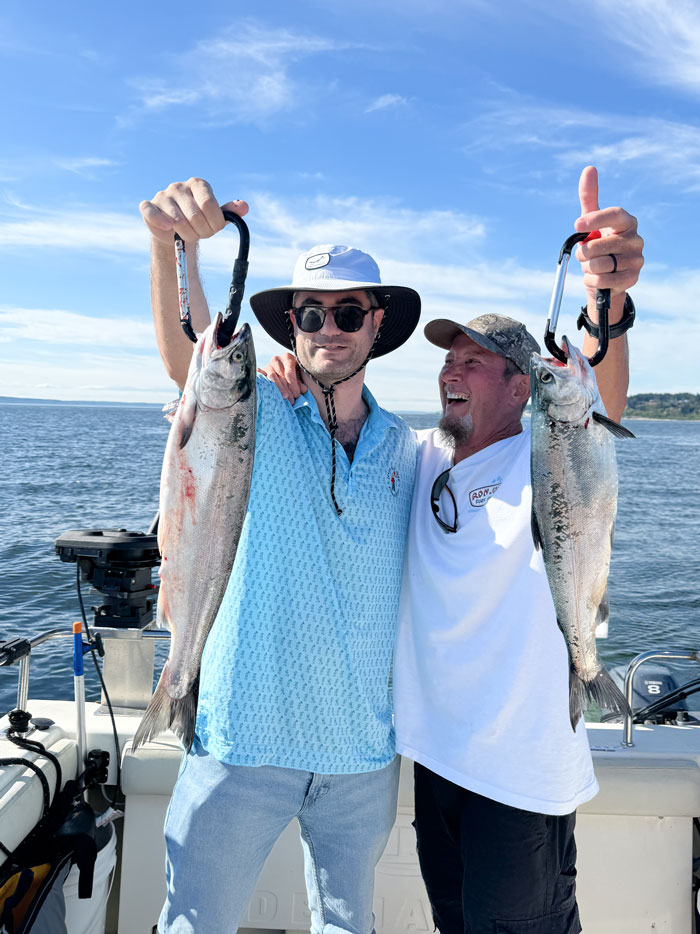 Friends showing limit of salmon on Seattle Puget Sound charter.