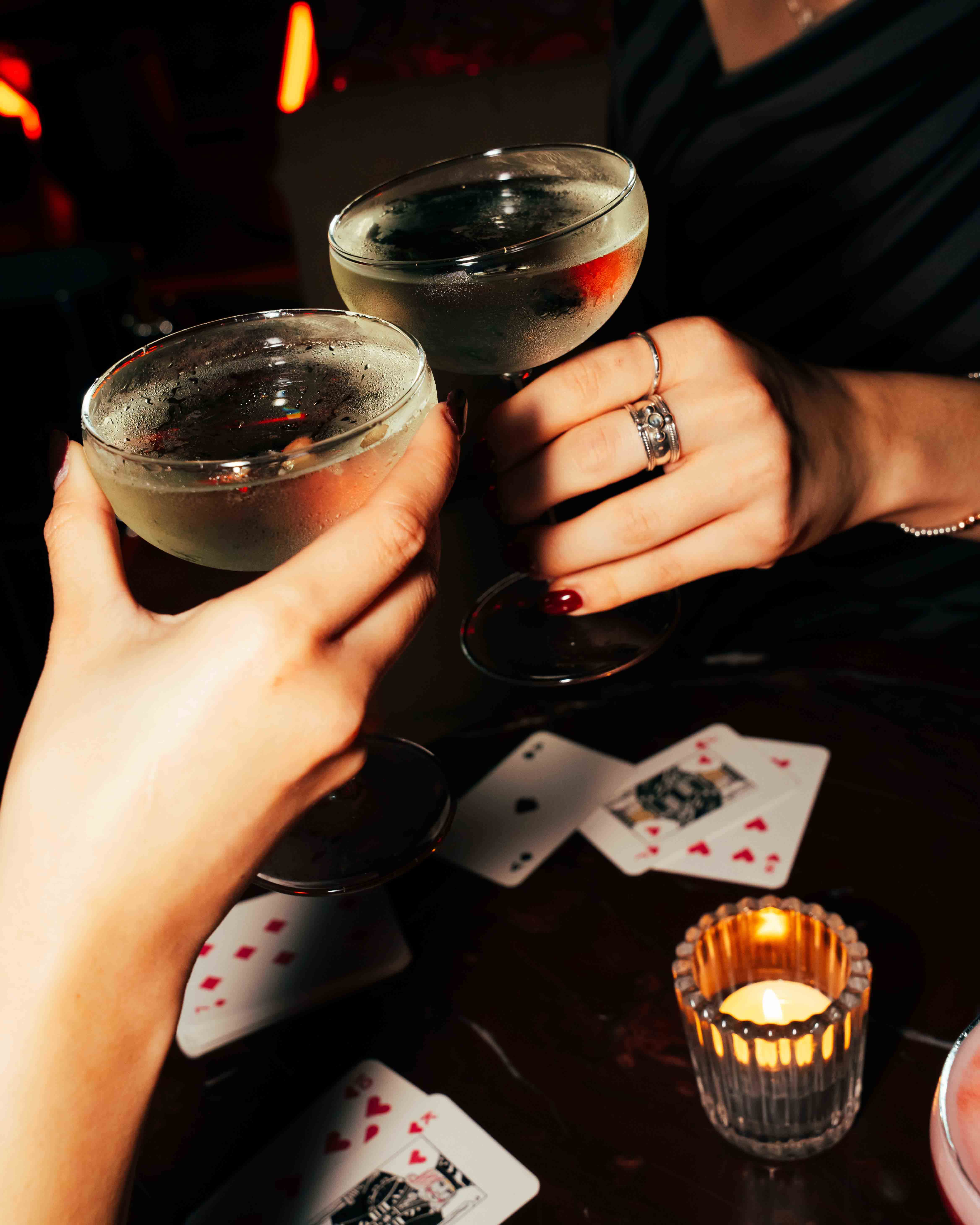 Freshly baked Margherita pizza with melted cheese, tomato sauce, and basil leaves, held by a person’s hand.