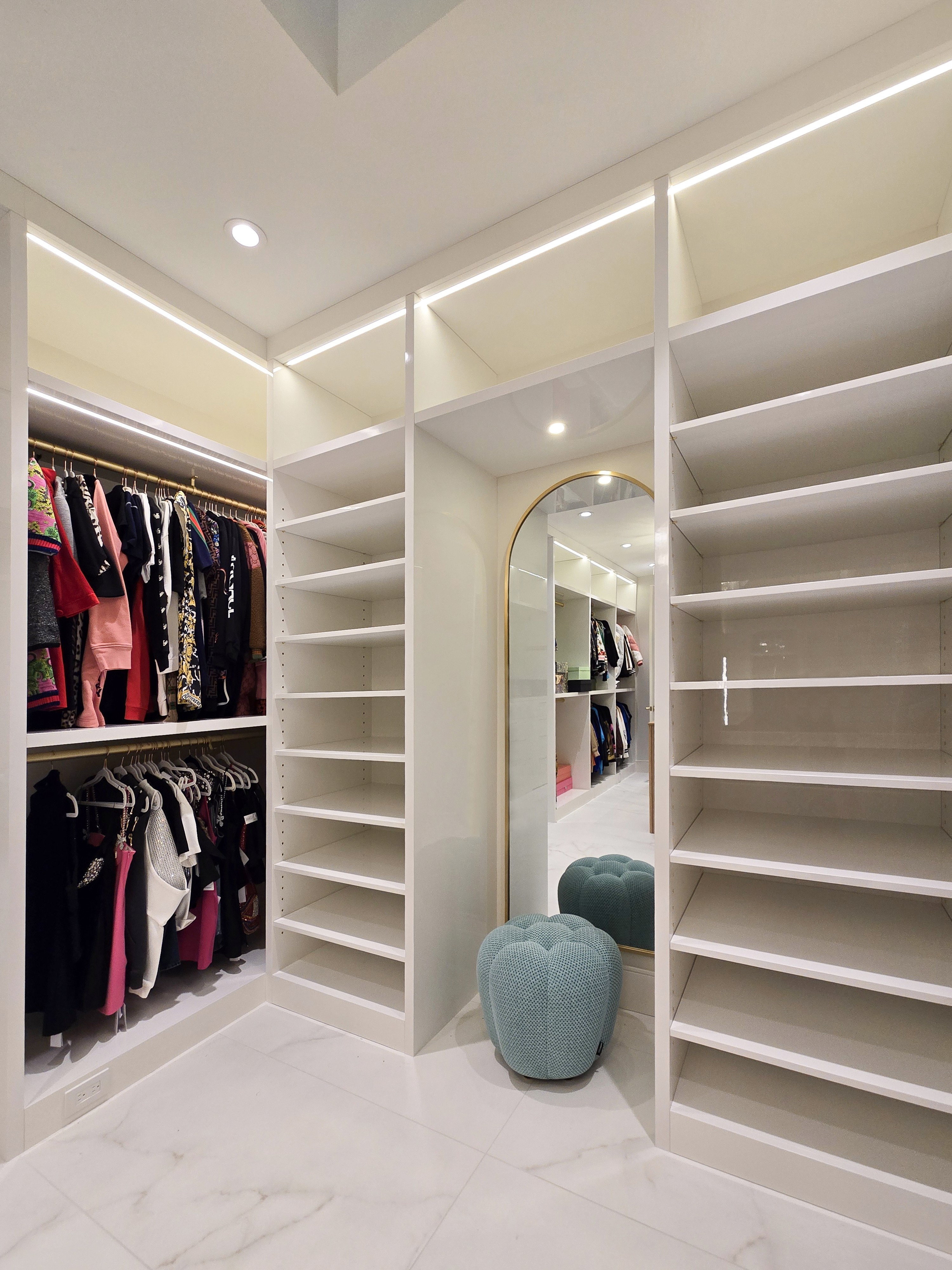 Image of Luxury primary ensuites featuring KHD Homes design-build closet with shelving, furniture, and window coverings.