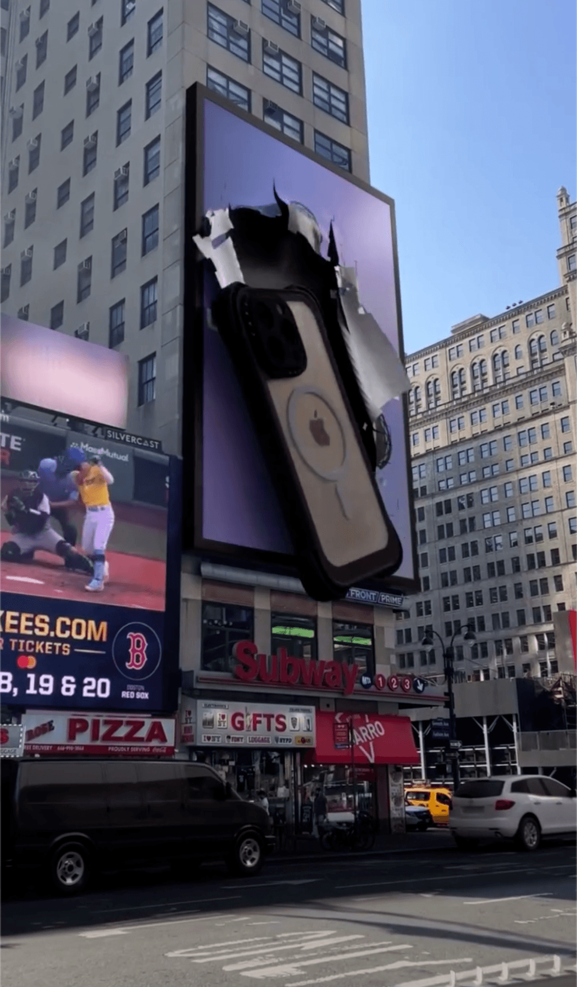 A 3D billboard showing a casetify phone case breaking through the screen over a city street